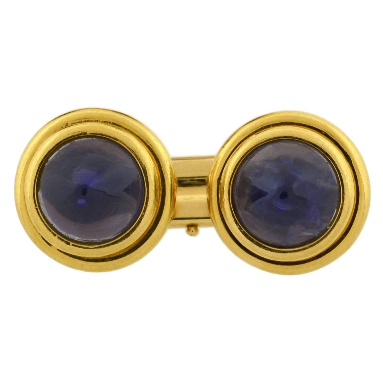 A fabulous pair of signed Bvlgari cufflinks from the Retro (ca1940) era! Crafted in 18kt yellow gold, each of these double-sided cufflinks has a round face and a vibrant iolite stone set in the center. The violet clored cabochon stones are smoothly