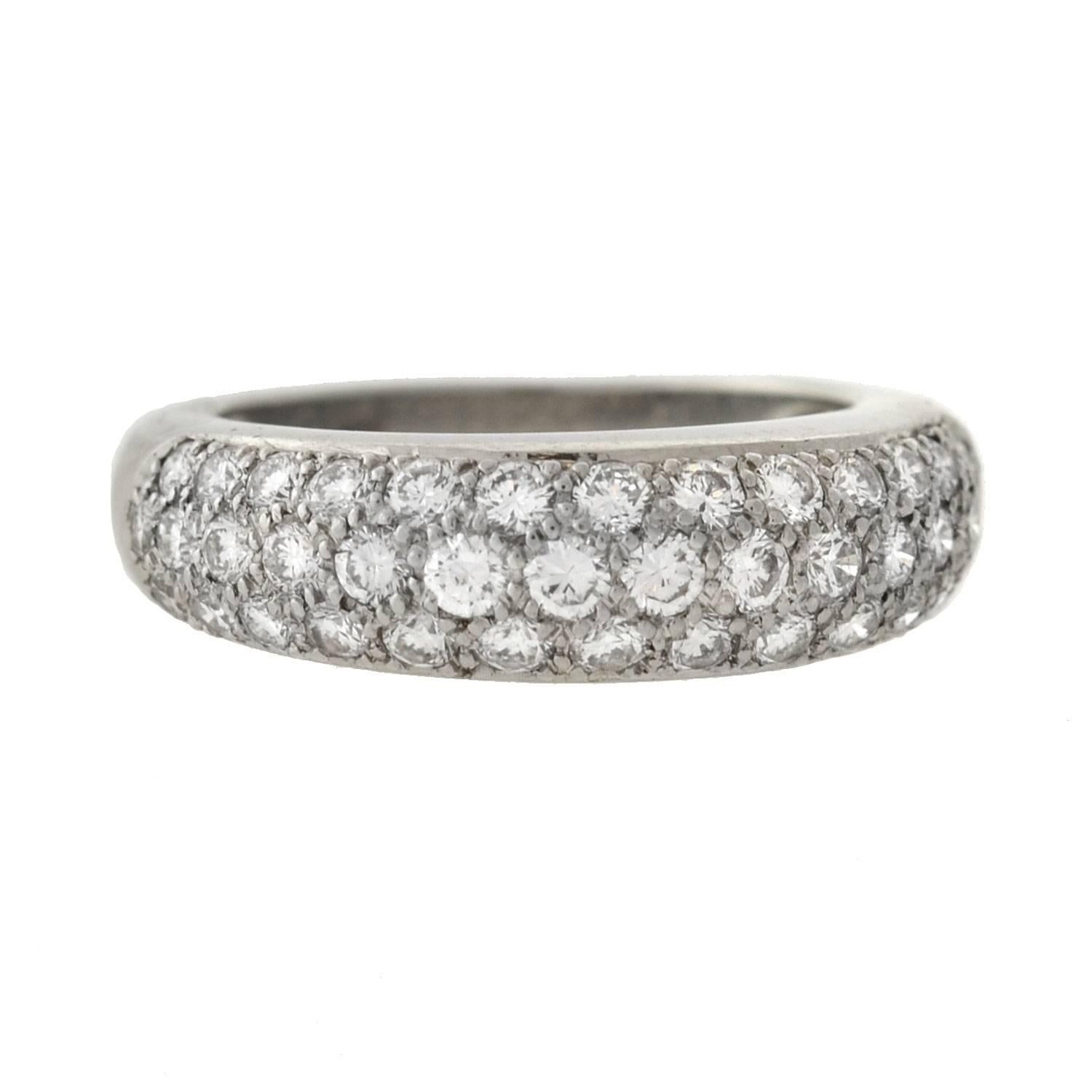 A stunning Vintage pavé diamond ring by legendary maker Cartier! From circa 1995, this wonderful piece is made of platinum and displays 3 glittering rows of diamonds. The band has 40 sparkling brilliant cut diamonds, which have a total overall
