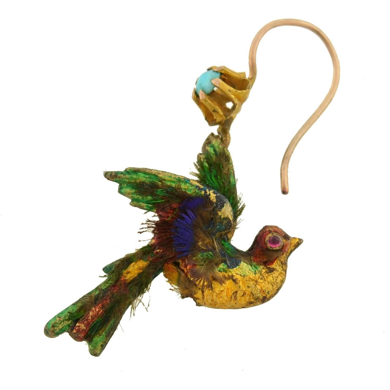 An extremely rare and unusual pair of English earrings from the Victorian (c.1880) era! Each of these artistic earrings is crafted 15kt yellow and carries the shape of an exotic bird. The birds have a 3-dimensional appearance and swing with lovely