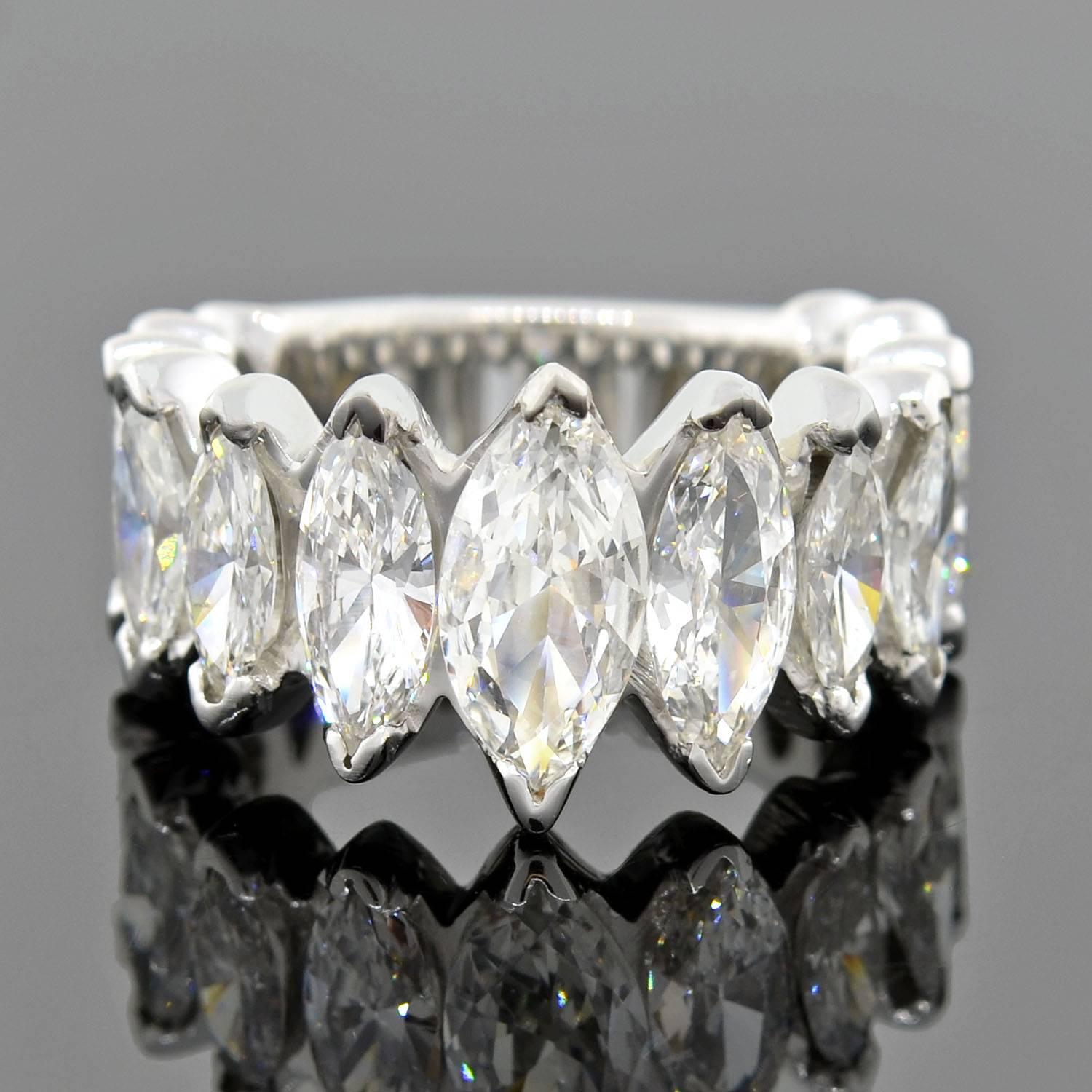 An incredible vintage diamond ring from the 1960s! This beautiful piece is made of platinum and has a dazzling design encrusted with 6.44ctw of sparkling diamonds. Set across the front are 13 marquise cut diamonds which rest in a beautiful,