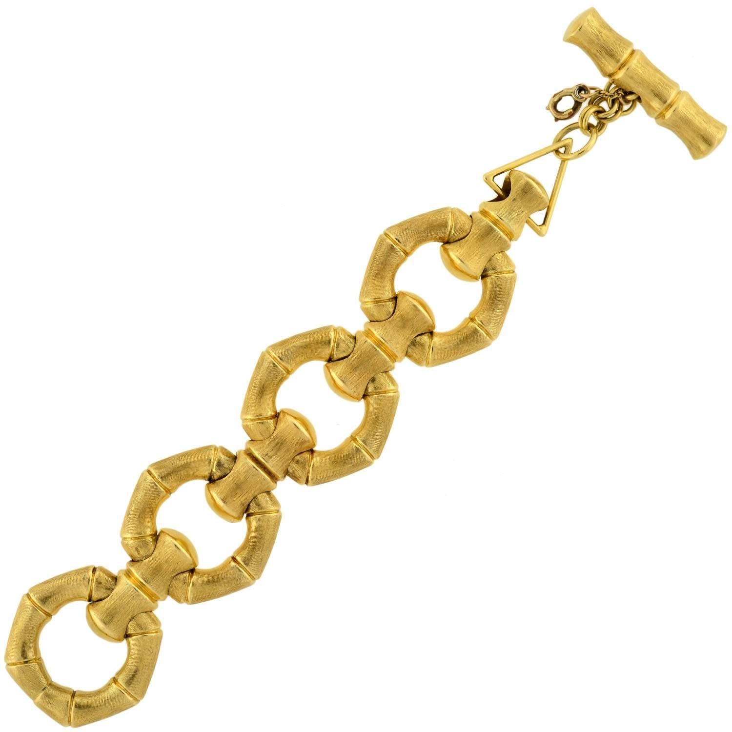 This vintage 18kt gold bracelet from the 1960s makes a very big statement! The stylish Italian-made piece is made of oversized "bamboo" links and has a very substantial look and feel. Each open link has a smooth surface on one side and a