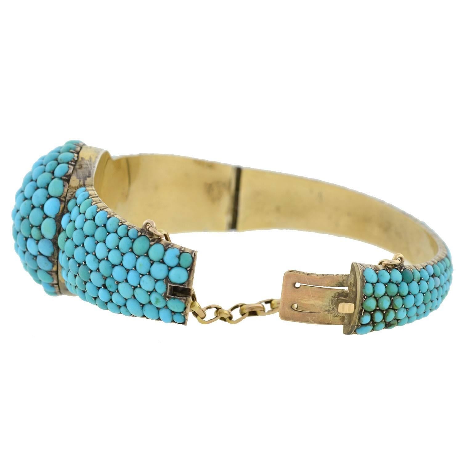 A spectacular turquoise bracelet from the Victorian (ca1880) era! Crafted in silver gilt, the entire outer surface of the magnificent piece is covered with beautiful pavé turquoise stones. A dome-shaped centerpiece gives a lovely 3-dimensional