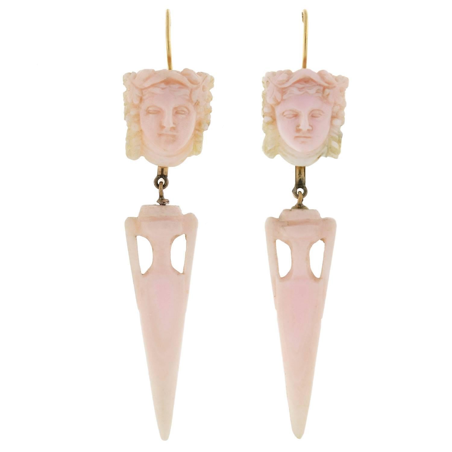 An absolutely fabulous hand carved angel skin coral set from the Victorian (ca1880) era! This fabulous set is comprised of a single pendant and a complimentary pair of earrings. The pendant hangs from a triangular, 14kt yellow gold frame that has a