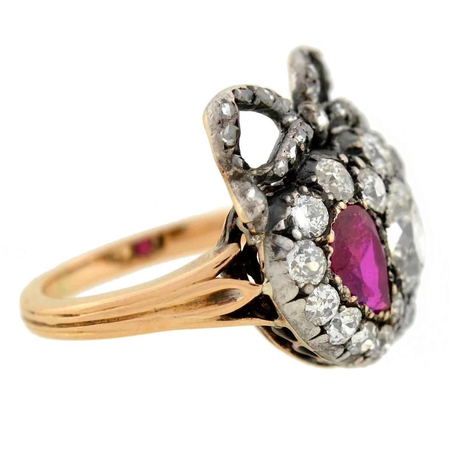 An absolutely exquisite diamond and ruby ring from the Victorian (ca1880) era! This breathtaking piece is made of sterling topped 15kt rose gold and has an incredible design. With a very royal appearance, a double heart centerpiece is the main focal