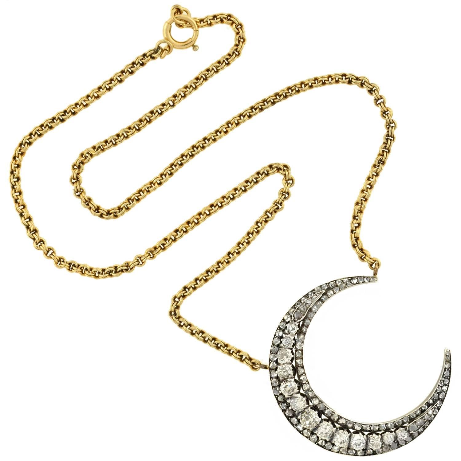 This diamond crescent necklace from the Victorian era (ca1880) is truly spectacular! Made of sterling-topped 18kt yellow gold, the piece depicts a crescent moon, which is quite substantial in size and mesmerizing in design. The entire surface is