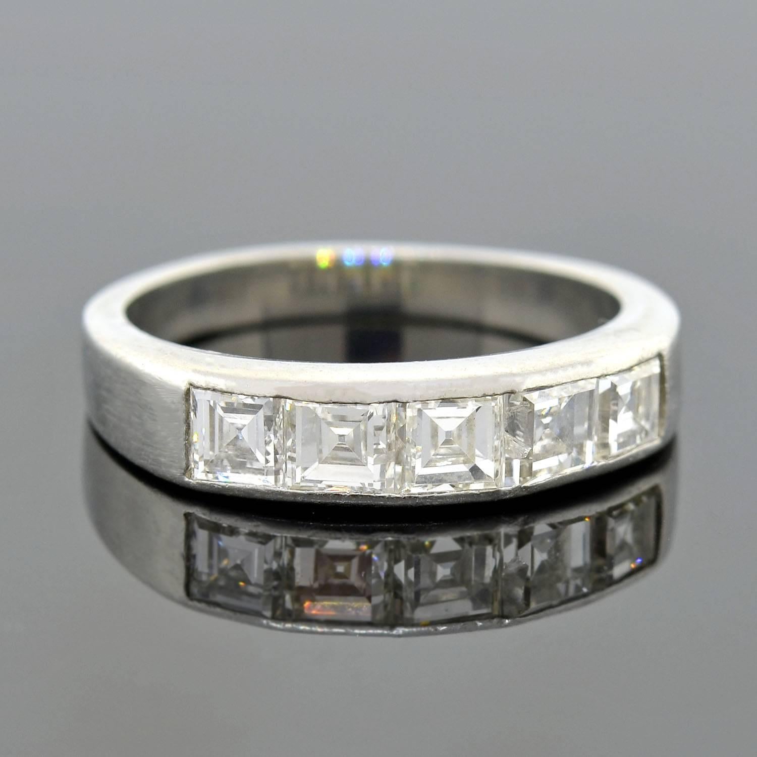 This vintage diamond half band from the 1960s is simply gorgeous! The ring is made of platinum and features a row of 5 Fancy Square Cut diamonds that line the front. Each diamond weighs approximately 0.25ct and rests in a seamless channel setting,