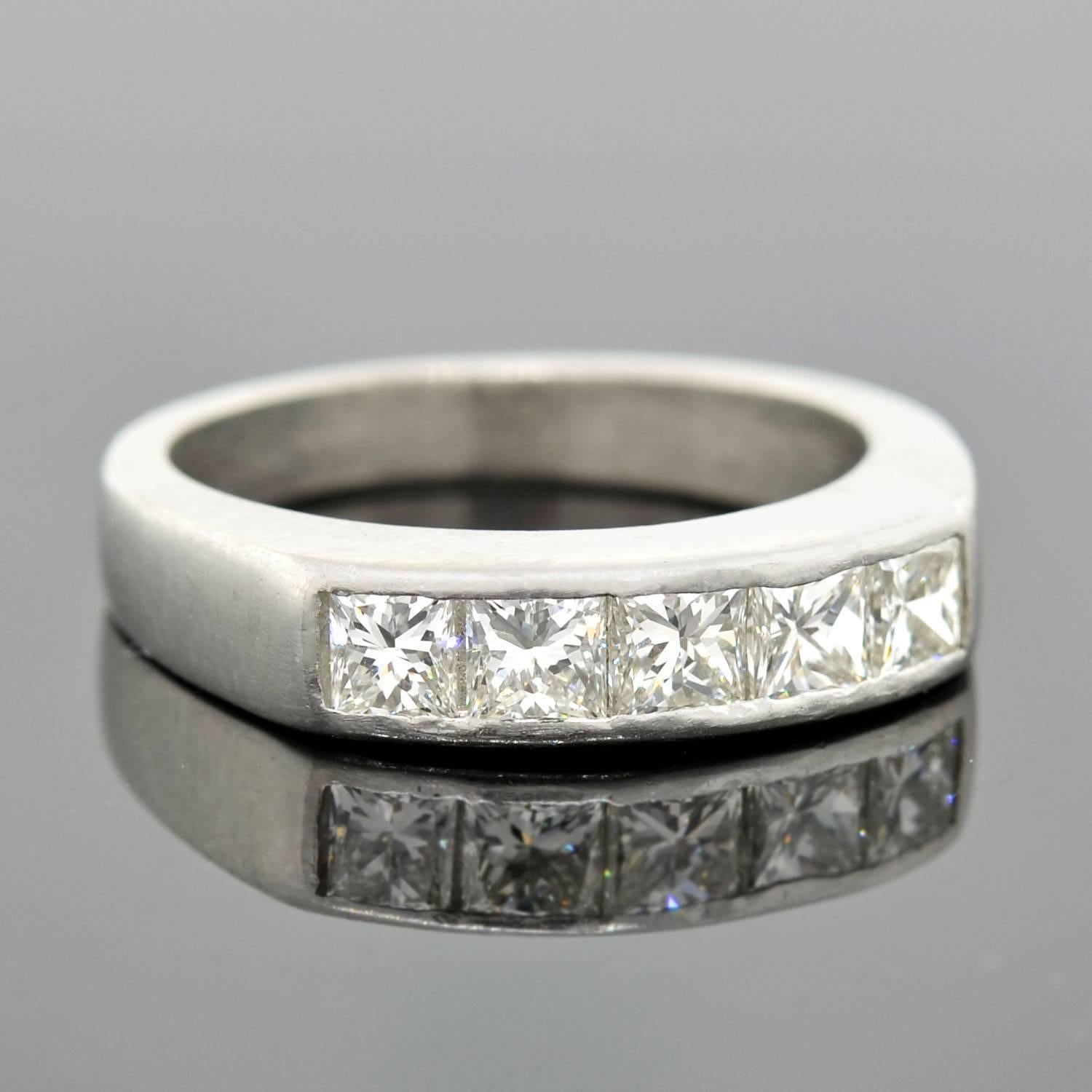This vintage diamond half band from the 1960s is simply gorgeous! The ring is made of platinum and features a row of 5 Radiant cut diamonds that line the front. Each diamond weighs approximately 0.18ct and rests in a seamless channel setting,