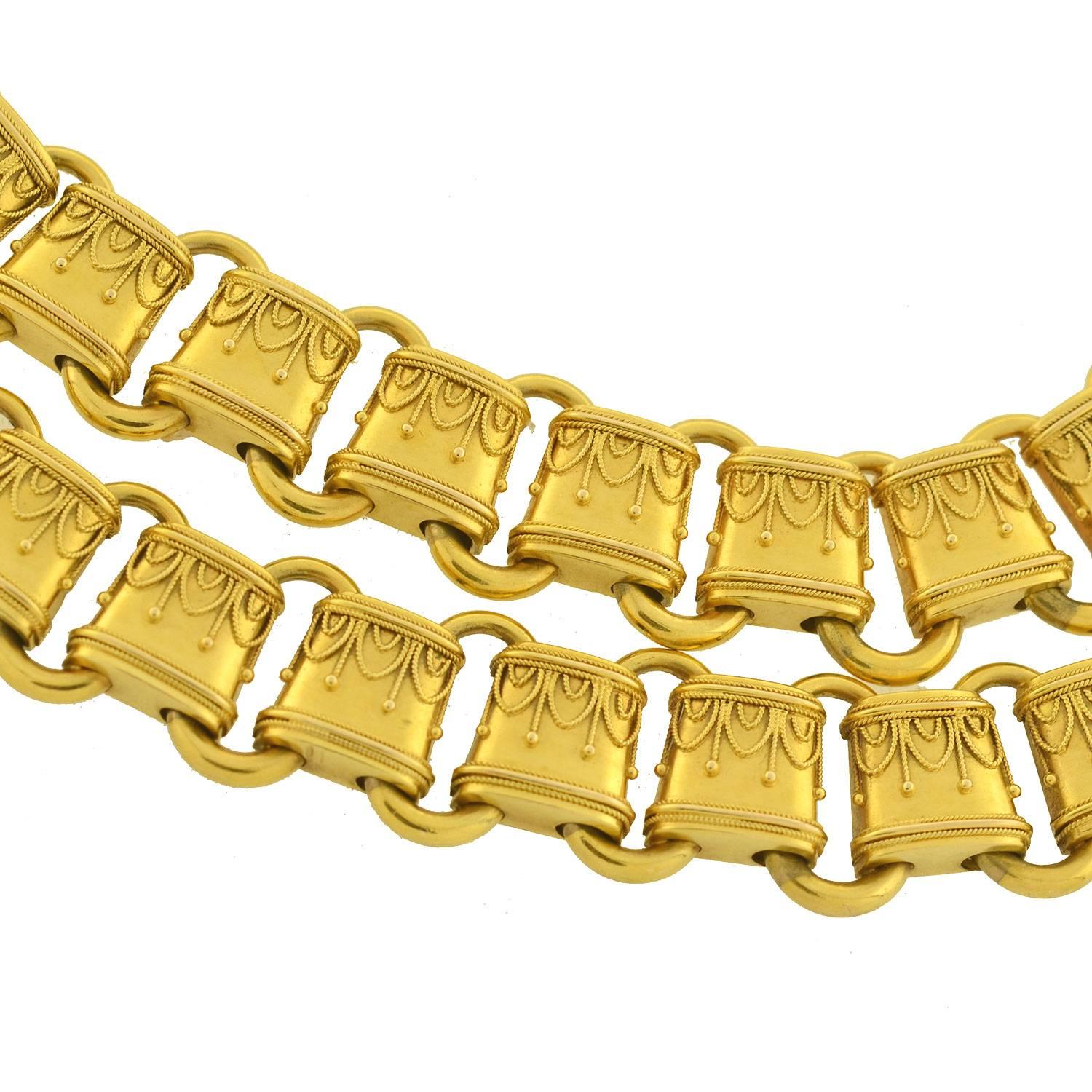 This gold book chain from the Victorian era (ca1880) is quite an outstanding piece! English in origin, it is hand crafted in vibrant 15ct yellow gold and has a wonderful Etruscan wirework motif applied to the surface. The design is comprised of