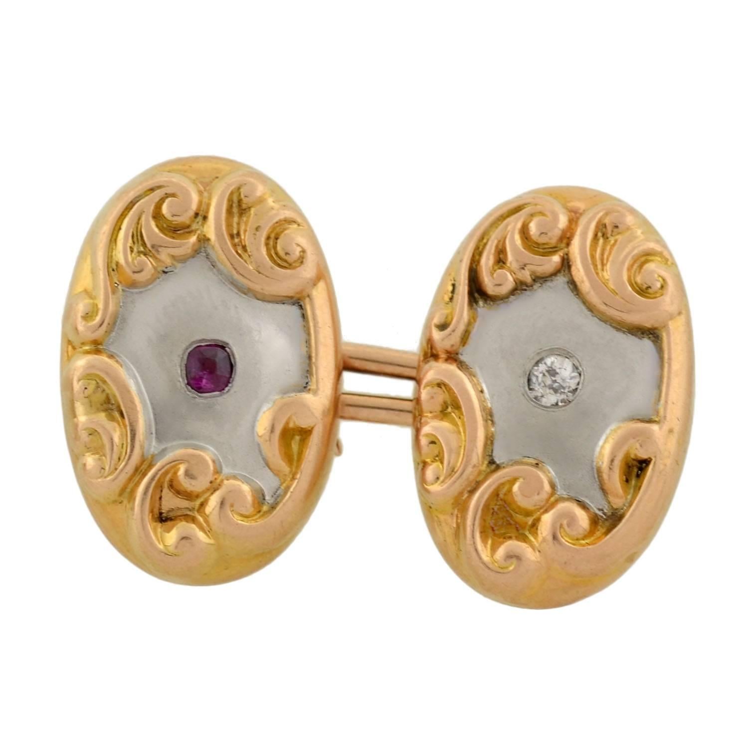A beautiful pair of mixed metals cufflinks from the Edwardian (ca1910) era! Made of platinum-topped 14kt yellow gold, these double-sided cufflinks have a lovely two-tone design with gemstone accents. Each cufflink face has a smooth platinum center,