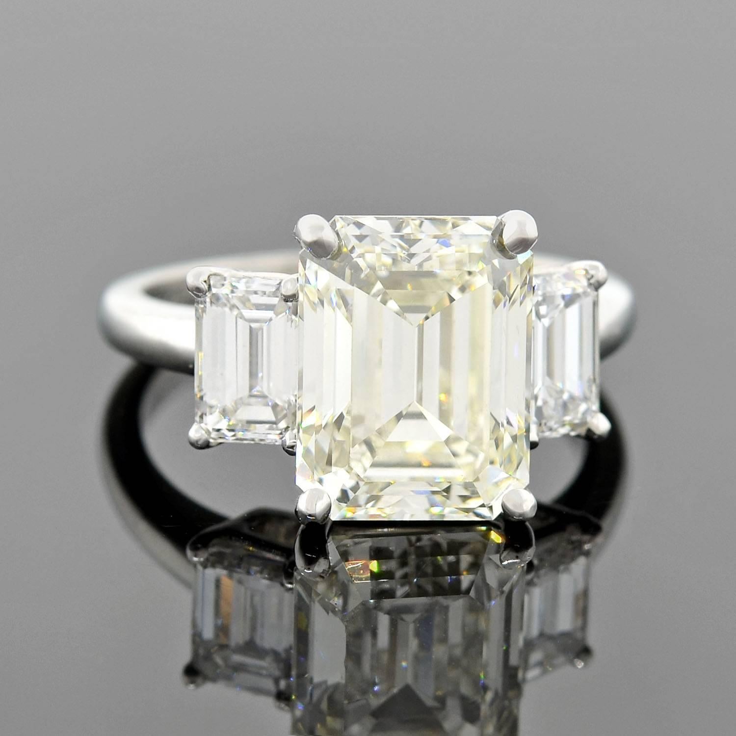 An exquisite Estate diamond engagement ring! Made of platinum, this gorgeous piece features a stunning Emerald Cut diamond, which weighs 4.13ct with M color and SI1 clarity. The diamond stone is held within a raised 4-prong setting and sits