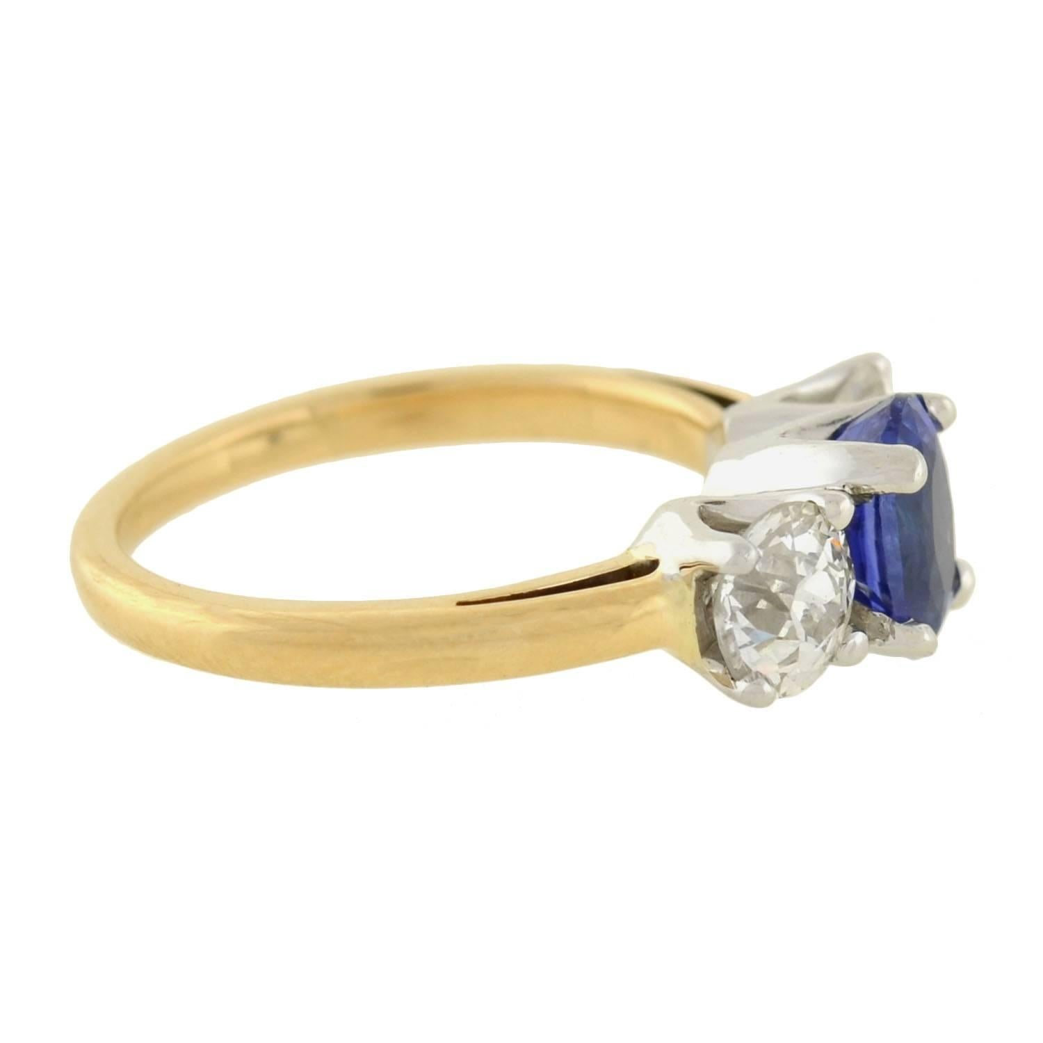 A gorgeous sapphire and diamond trilogy ring from the Art Deco (ca1930s) era! The 18kt mixed metals setting combines a yellow gold band with white prongs for a lovely 2-tone effect. A trio of beautiful stones rest within the prongs, including an