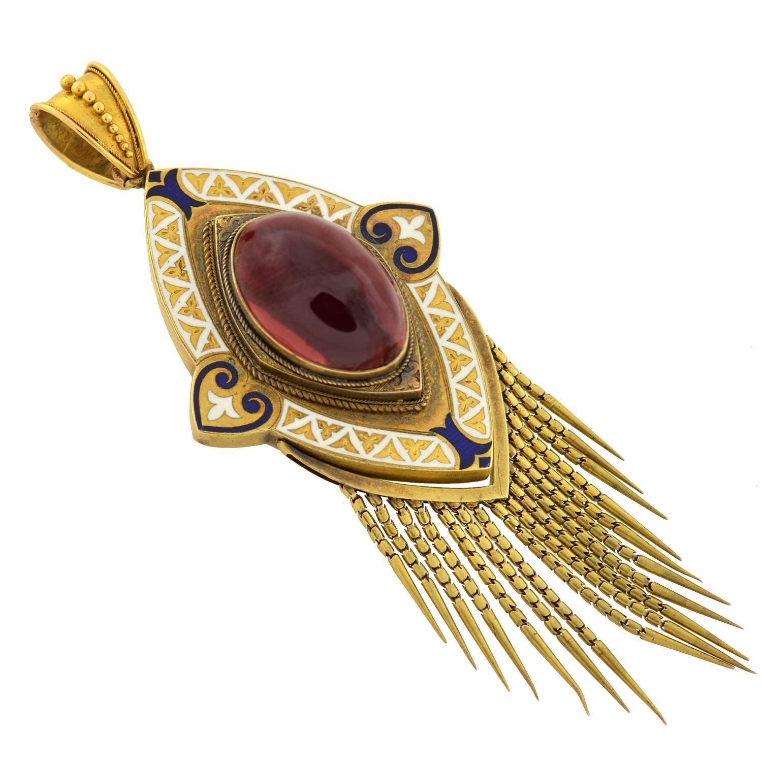 A fabulous garnet pendant from the Victorian (ca1880) era! This eye-shaped pendant is crafted in 15kt yellow gold and is detailed with gorgeous hand-etched details and navy and white enamel. Resting in the center of the piece is a very large
