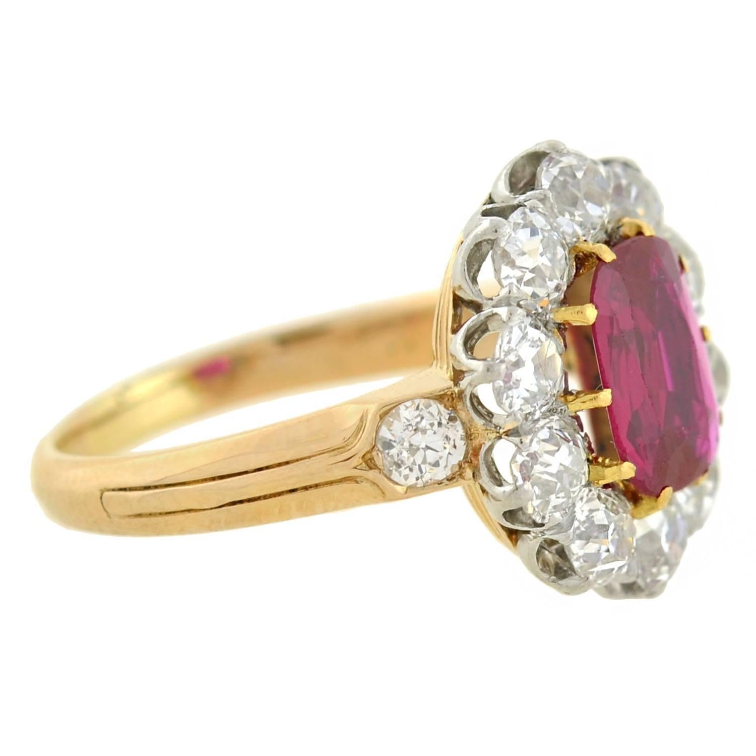 A truly spectacular ruby and diamond cluster ring from the Edwardian (ca1910) era! This outstanding ring is crafted in vibrant 18kt gold with a platinum top. Prong set at the center is a gorgeous Burma ruby, which is a Cushion Mixed Cut weighing