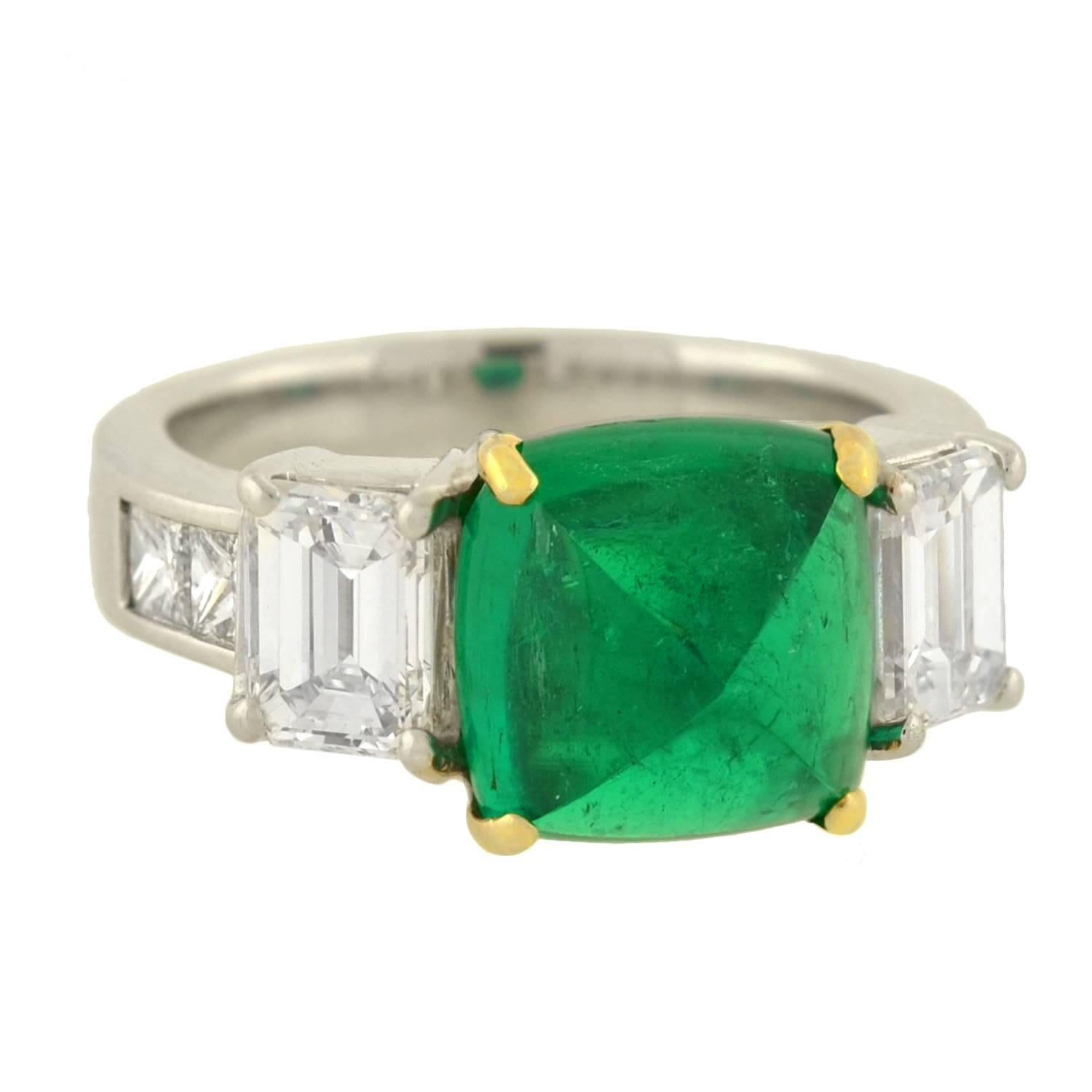 An absolutely phenomenal Estate emerald and diamond ring! The ring, which is made of 18kt white gold, has a bold natural pyramidal cabochon emerald set within it. The stone, which is square in shape, has exquisite, luscious green color and a total