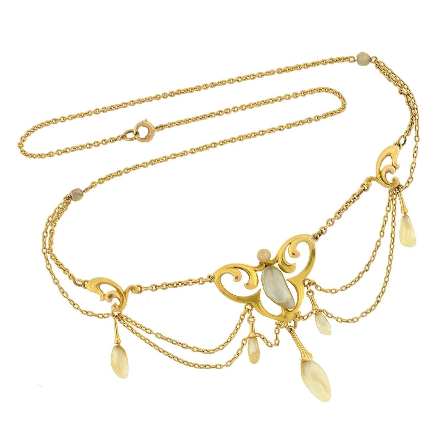 This exquisite pearl festoon necklace is a signed piece by Krementz from the Art Nouveau (ca1910) era! Crafted in 14kt yellow gold, the curvilinear design has a flowing, organic appearance that is highly characteristic of the Art Nouveau aesthetic.