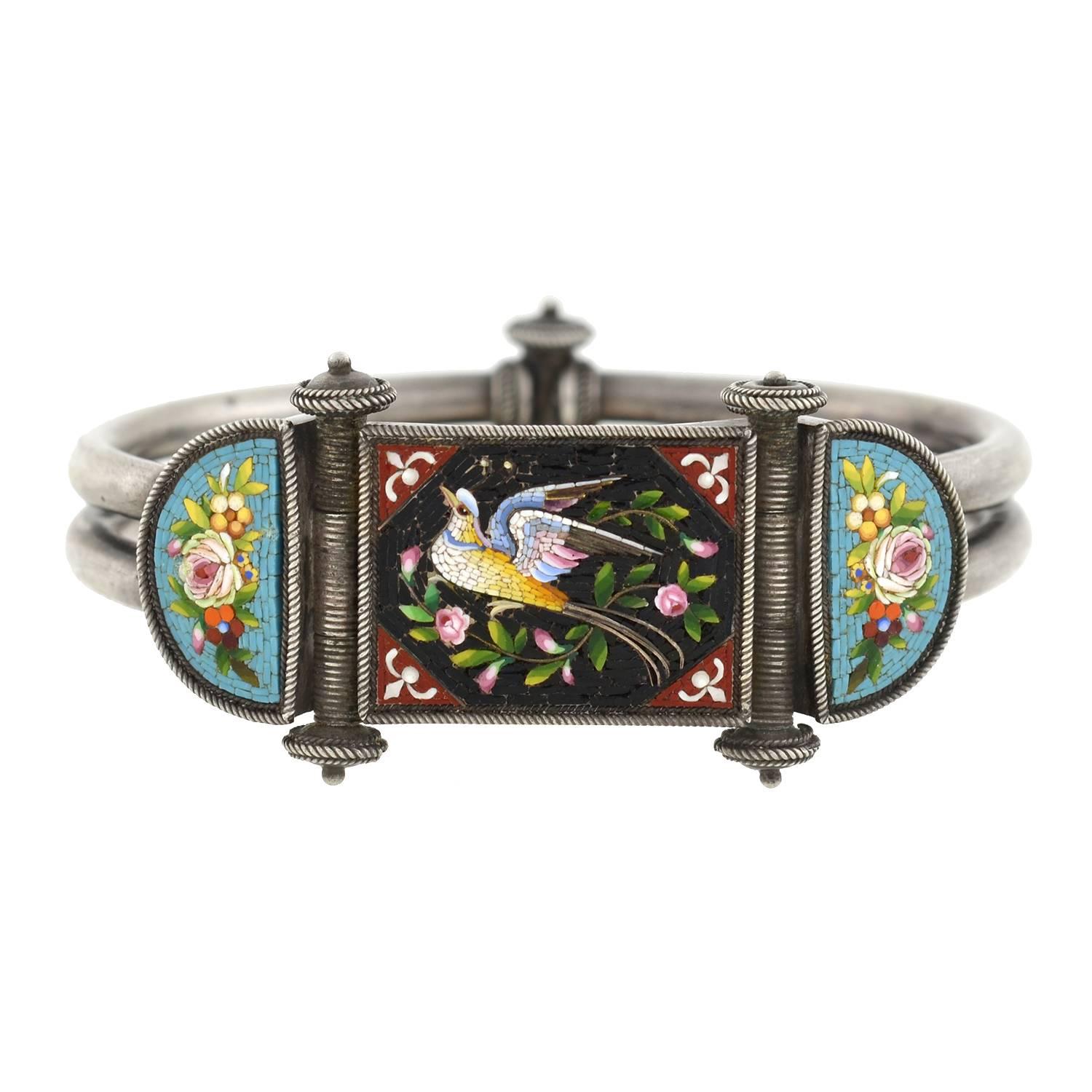 A fantastic and unusual micro mosaic bracelet from the Victorian (ca1880) era! Made of sterling silver, the bangle style bracelet is comprised of two tubular links, which form the band of the bracelet. At the front is a marvelous micro mosaic design