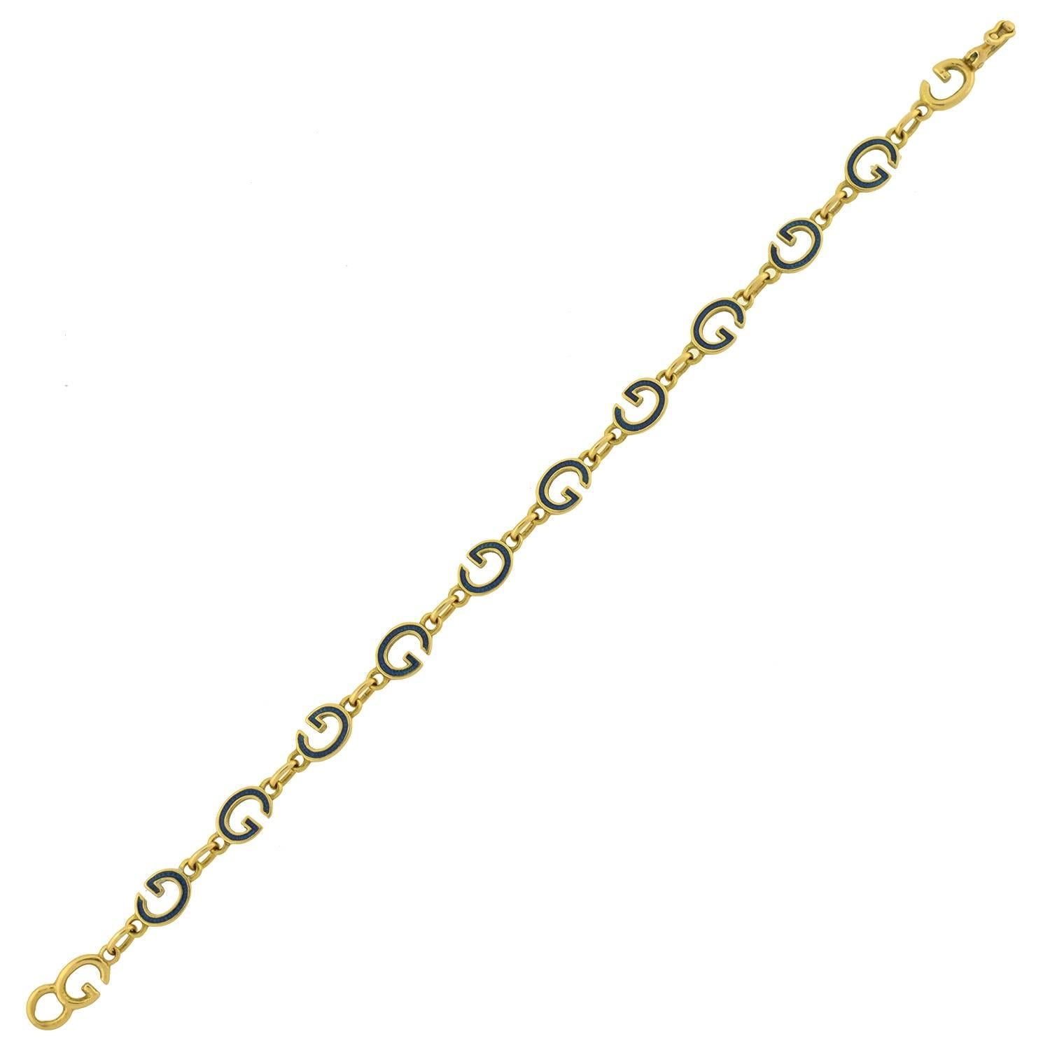 A fabulous gold and enamel Gucci Bracelet! This vintage piece is most likely from the 1970's and comprised of 12 "G" links that are made of 18kt yellow gold. Connected by smaller, oval shaped links, all but 2 of the "G" links are