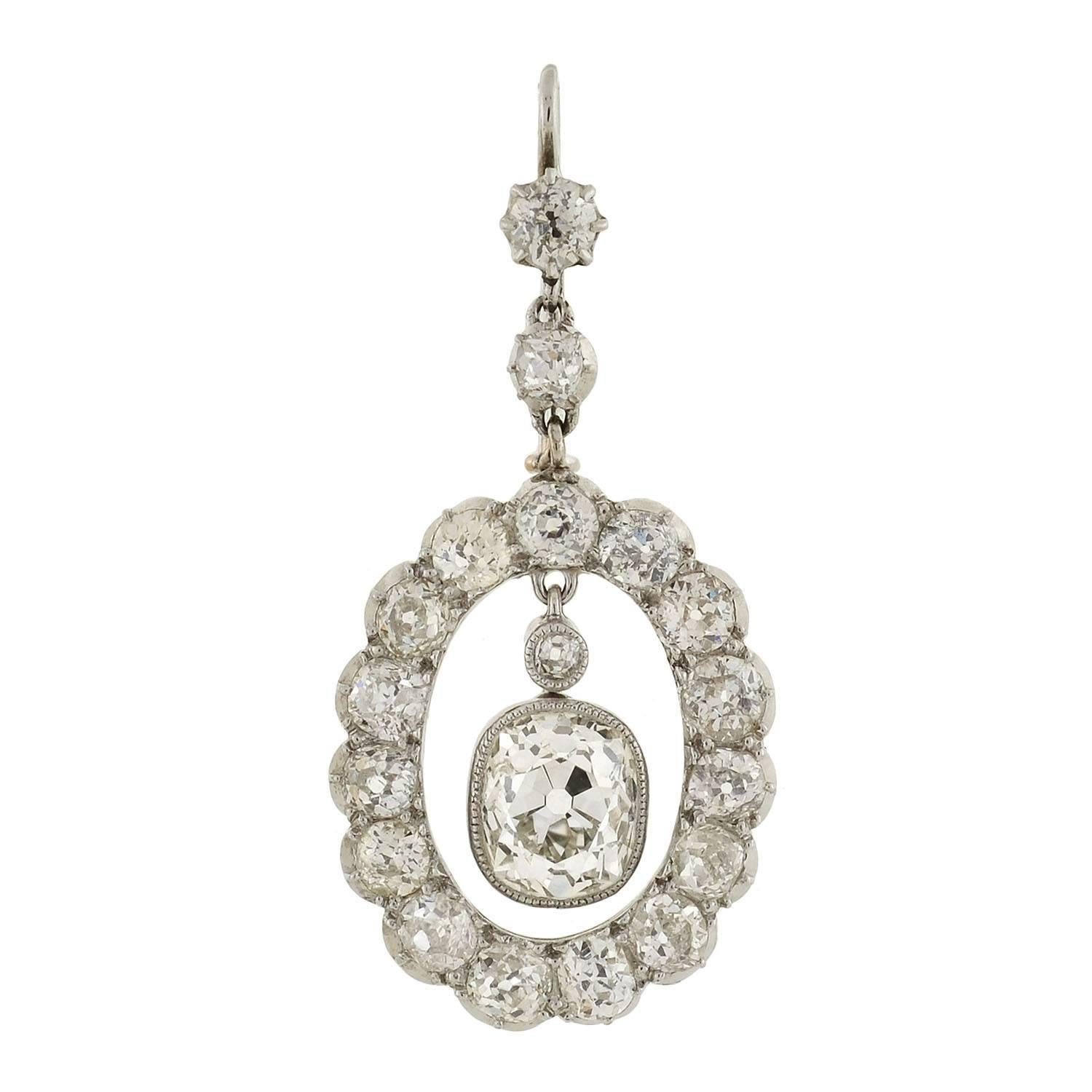 An incredible pair of diamond encrusted earrings from the Edwardian (ca1910) era! The earrings are crafted in platinum and have a spectacular open halo design. Dangling in the center is a luscious cushion mine cut diamond, which is contained within