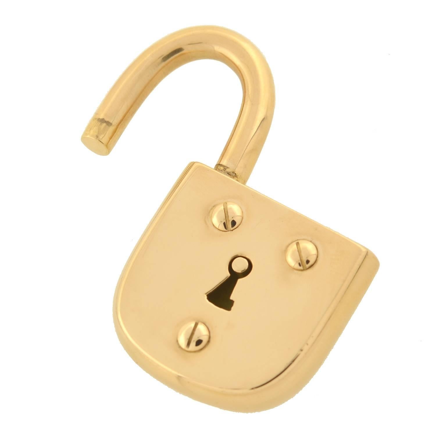 This impressive padlock is a signed estate piece by Tiffany & Co.! The pendant has a stylish and functional padlock motif crafted in 18kt gold, and is quite substantial both in size and appearance. Reminiscent of a Victorian era padlock, the