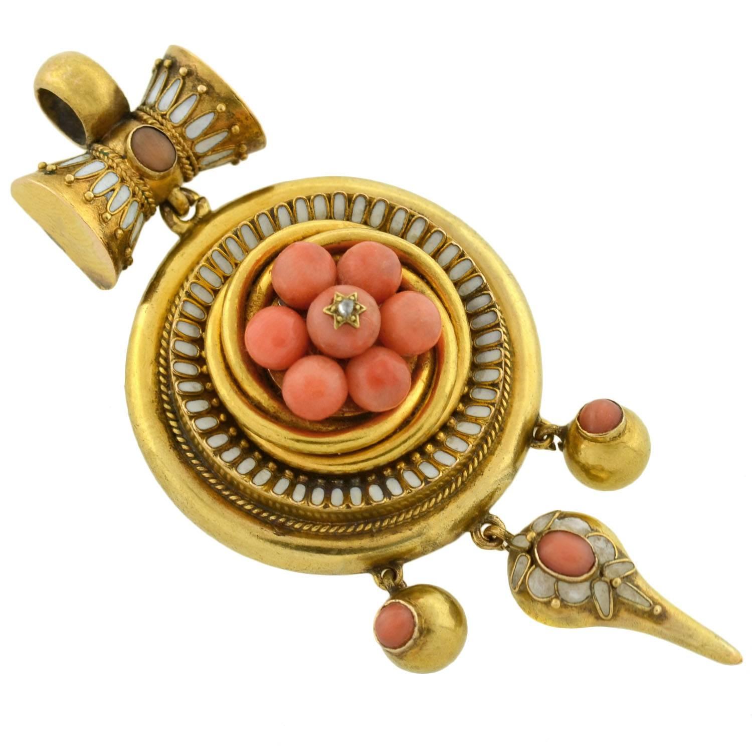 A magnificent coral locket/pendant from the Victorian (ca1880) era! Made of vibrant 18kt gold, the piece is highly detailed and particularly large in size. A cluster of 7 coral cabochons rest at the center, which are smoothly polished and display