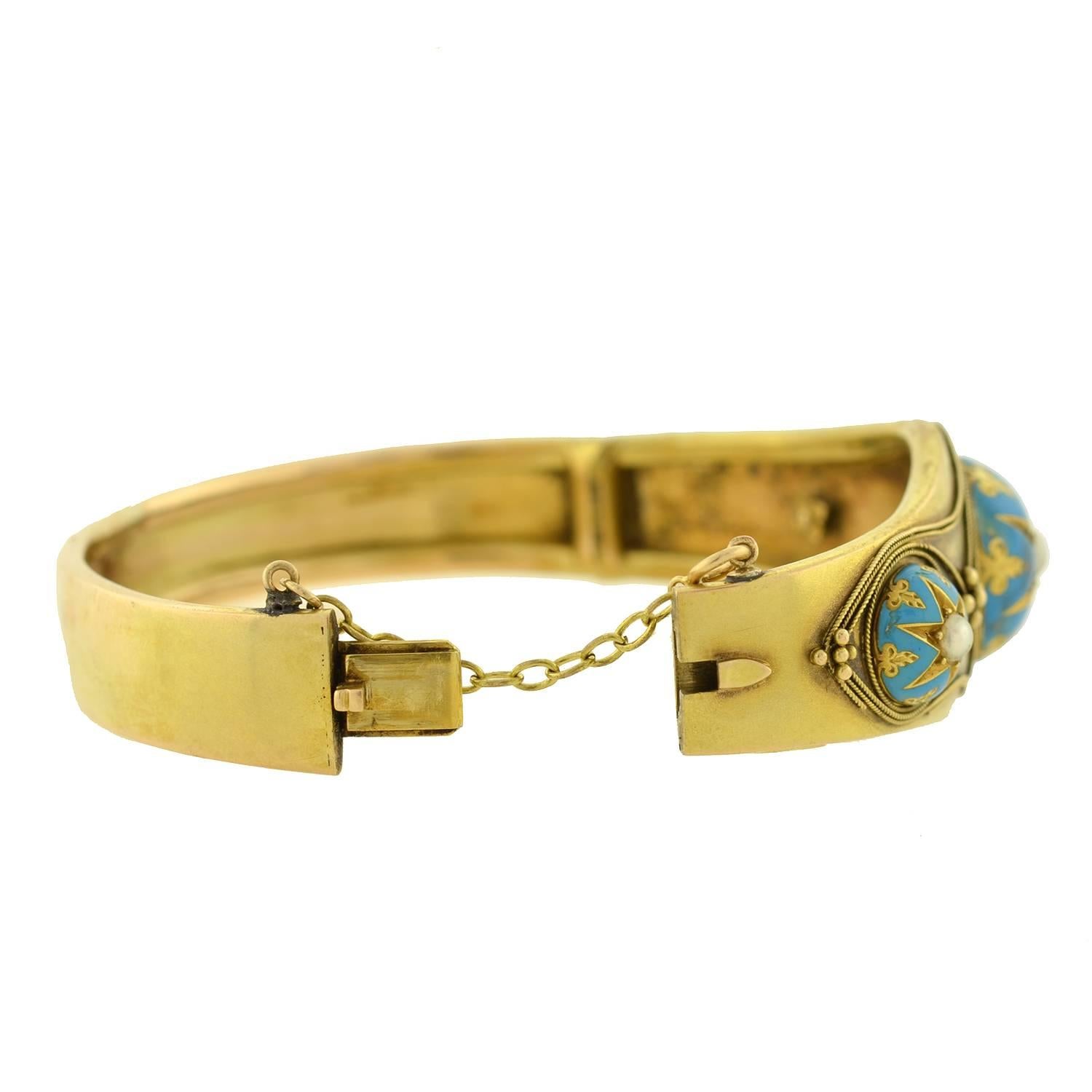 A beautiful and unusual bangle bracelet from the Victorian (ca1880) period! Crafted in 15kt gold (indicating English origin), this fabulous piece has a very eye-catching design. Three raised domes decorate the front, each with a starburst motif and
