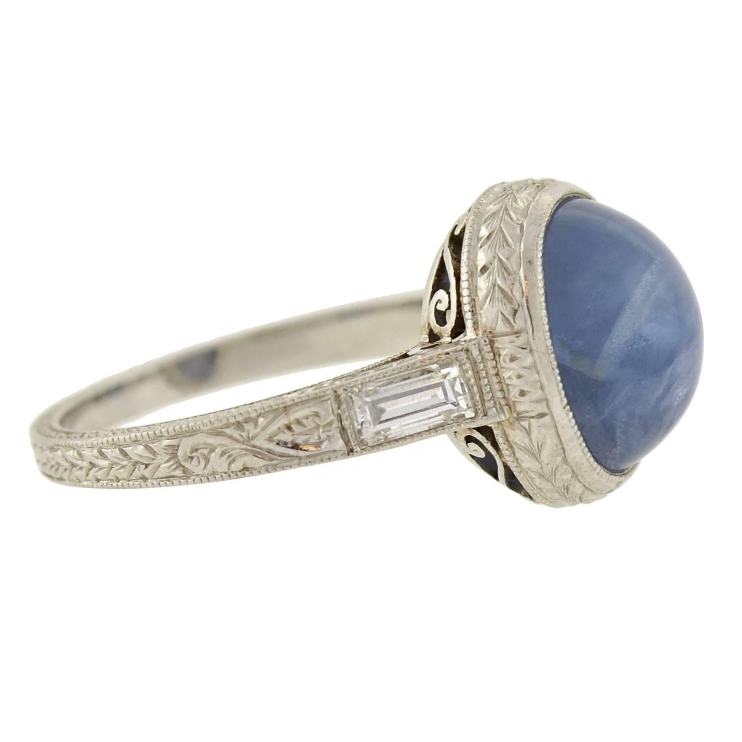 A beautiful star sapphire ring from the Art Deco (ca1920) era! This alluring ring holds a 2.50ct star sapphire cabochon at the center of a feminine platinum mounting. When turned in the light, the periwinkle blue stone reveals iridescent flashes at