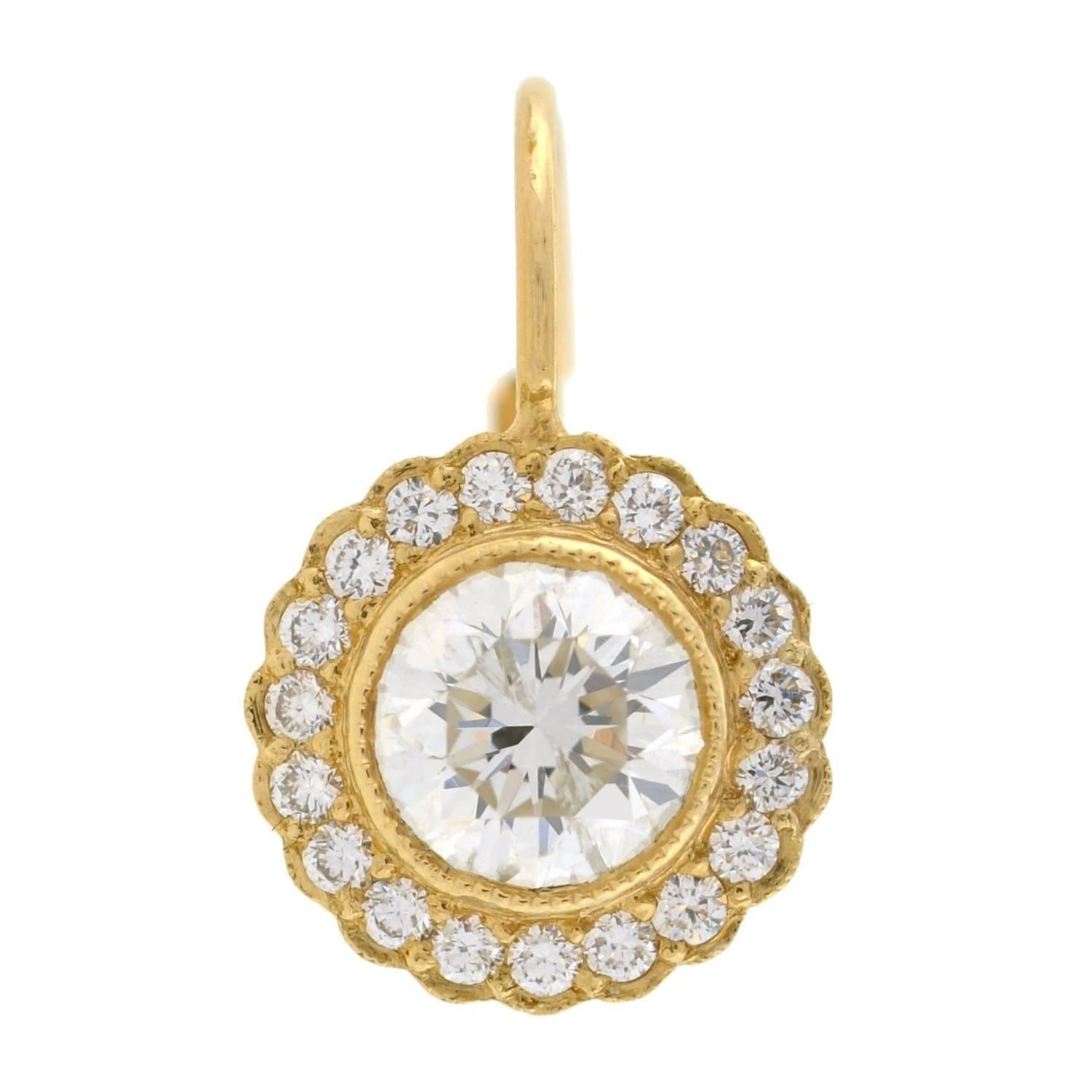 These estate diamond halo earrings are simply stunning! Each earring is crafted in vibrant 14kt gold, and features a sparkling cluster of diamonds. The center stones are Transitional European Cuts, which rest in a milgrained bezel setting. The