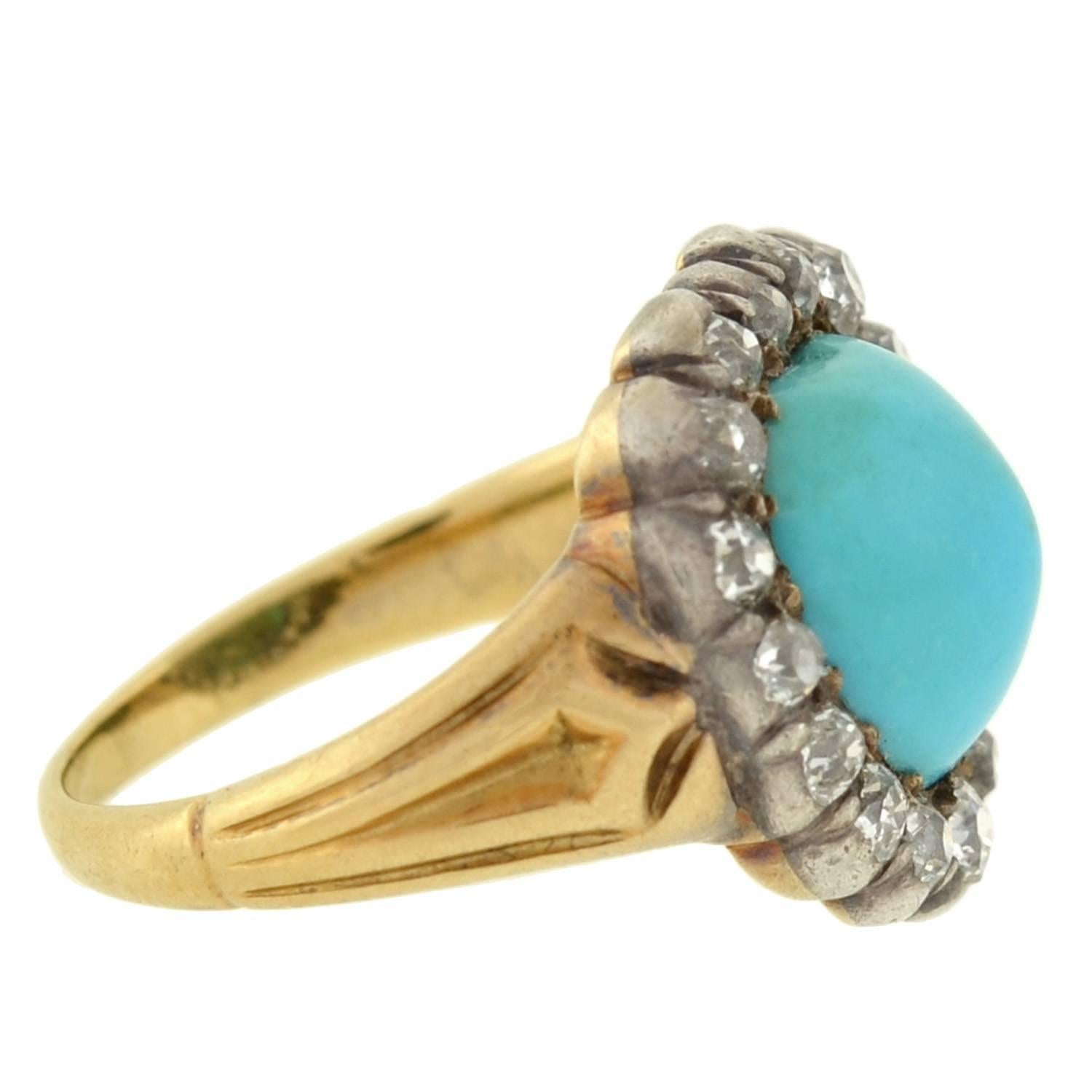 An absolutely stunning turquoise and diamond ring from the Victorian (ca1880) era! This fabulous heart-shaped piece has a 15kt yellow gold band and adorns a turquoise cabochon which rests amidst a border of diamonds. Resting in a sterling topped