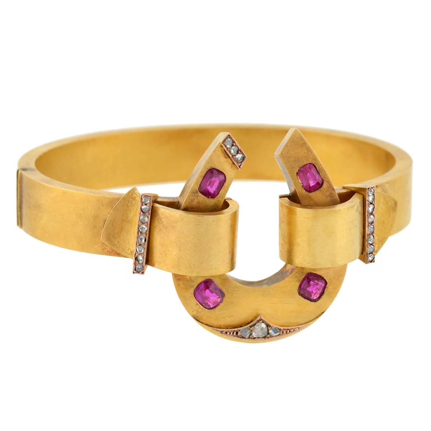 An outstanding horseshoe bracelet from the Victorian (ca1880) era! This incredible 3-dimensional bangle is crafted in vibrant 18kt gold, and is quite substantial in both size and appearance. A large open horseshoe rests at the center, grasped