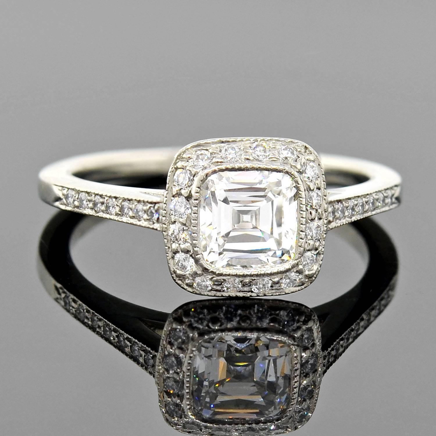This gorgeous estate diamond engagement ring is an original Tiffany & Co. design! Named the "Tiffany Legacy ®" Diamond ring, it features a patented cushion cut diamond at the center of a platinum setting.

As described by Tiffany &