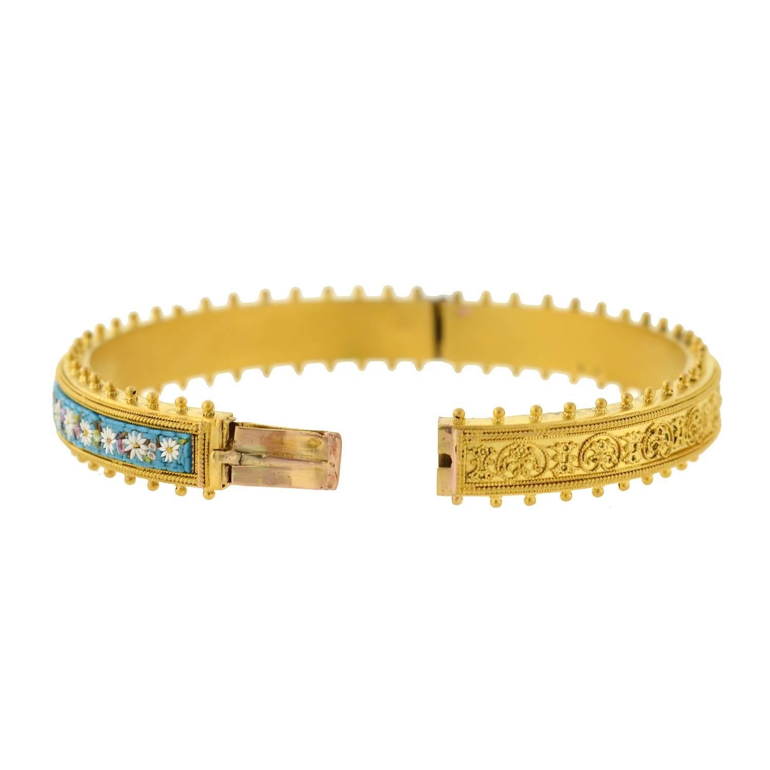 An exceptional micro mosaic bracelet from the Victorian (ca1880) era! Made of vibrant 15kt gold, this slim bangle displays an incredible micro mosaic design on one side, and an Etruscan wirework motif on the other. The micro mosaic craftsmanship is