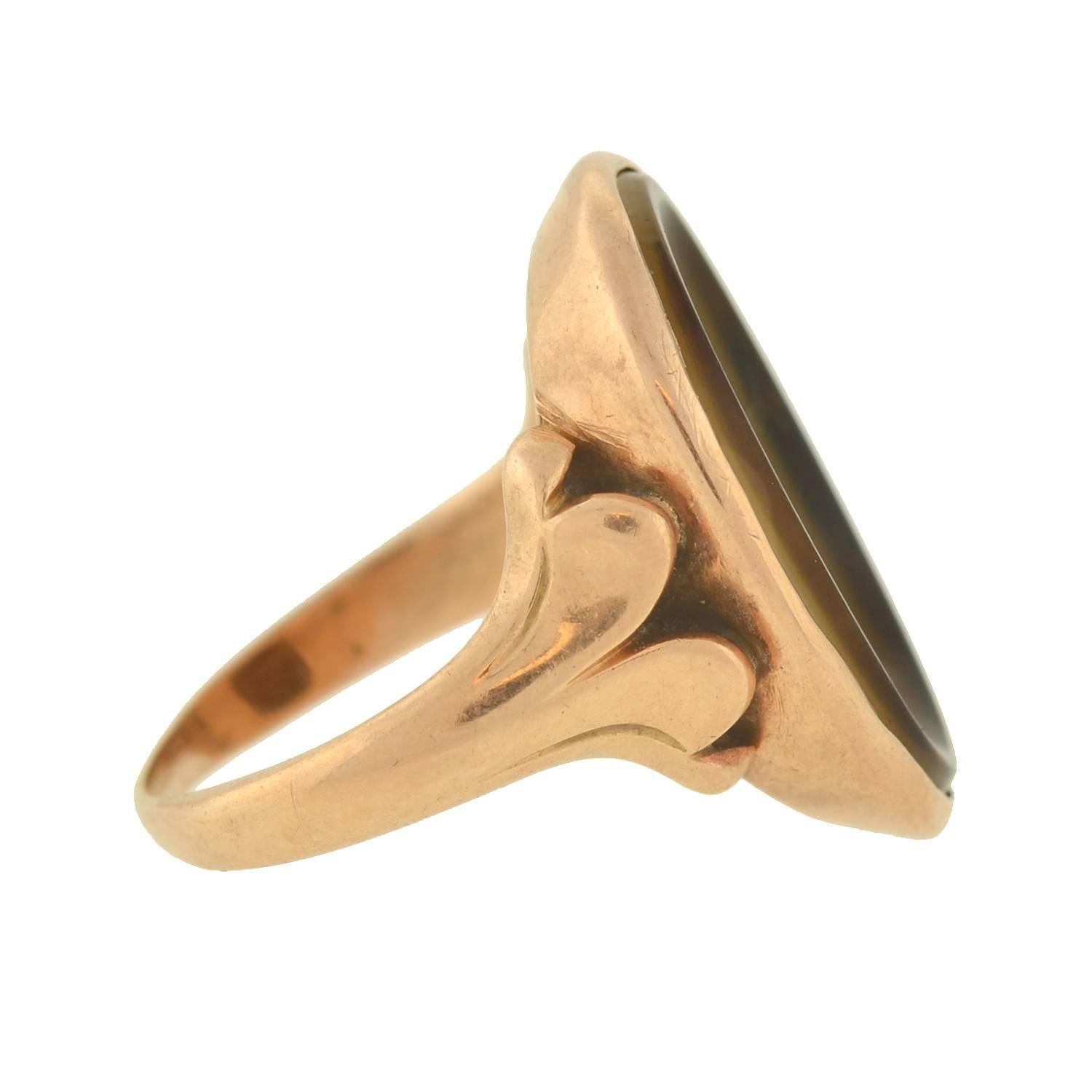 This unusual ring from the late Georgian era (ca1830) is truly one-of-a-kind! Crafted in 14kt gold, the beautiful design features a unique banded agate centerpiece. The hand-carved stone is concave in shape, forming an open basin with a smoothly