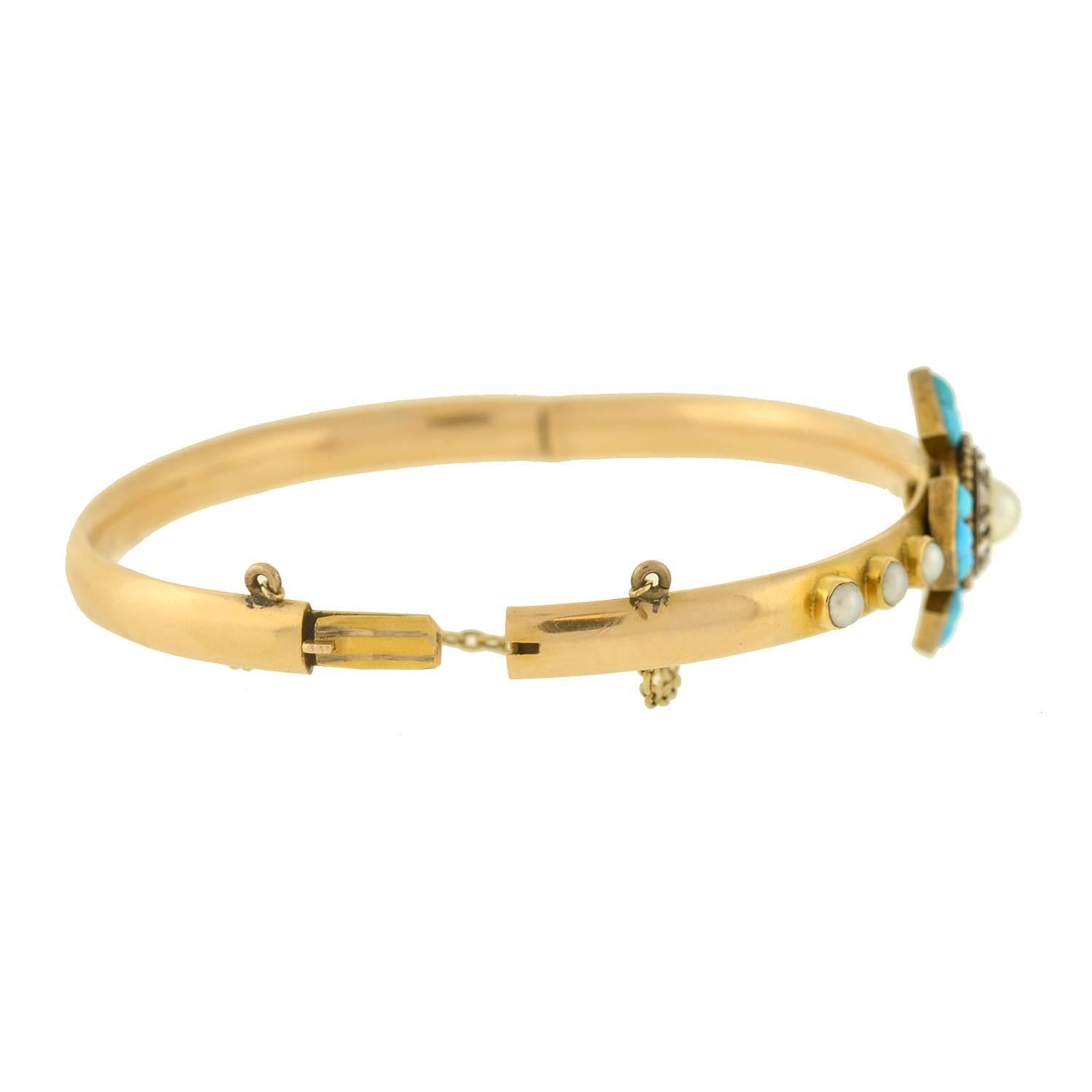 A spectacular turquoise, pearl and diamond bracelet from the Victorian era (ca1880s)! Made of vibrant 14kt yellow gold, the bracelet is a hinged bangle style with a stunning gemstone-encrusted centerpiece face. Resting at the center is a magnificent
