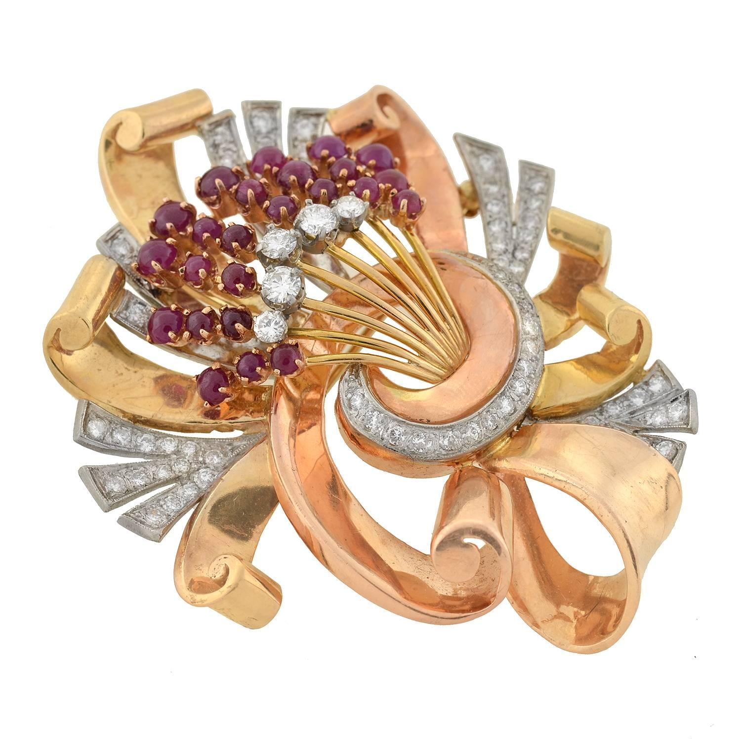 A magnificent bouquet brooch from the Retro (ca1940s) era! This outstanding mixed metals piece is very substantial in size, and features an array of luscious rubies and sparkling diamonds. The tri-tone design is crafted in 18kt yellow gold, 18kt