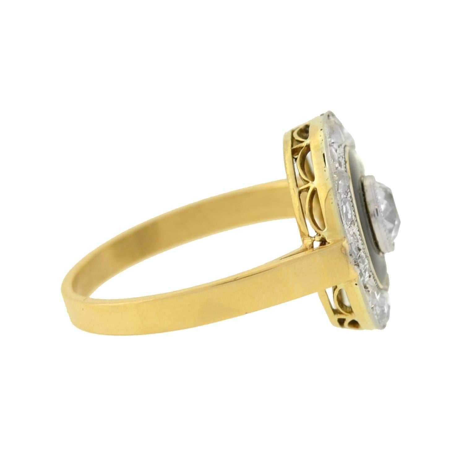 A very striking diamond ring from the Edwardian (ca1901) era! This gorgeous mixed metals design is crafted in 18kt gold and topped in platinum. The flat, circular centerpiece features a sparkling old Mine Cut diamond at the center, which weighs