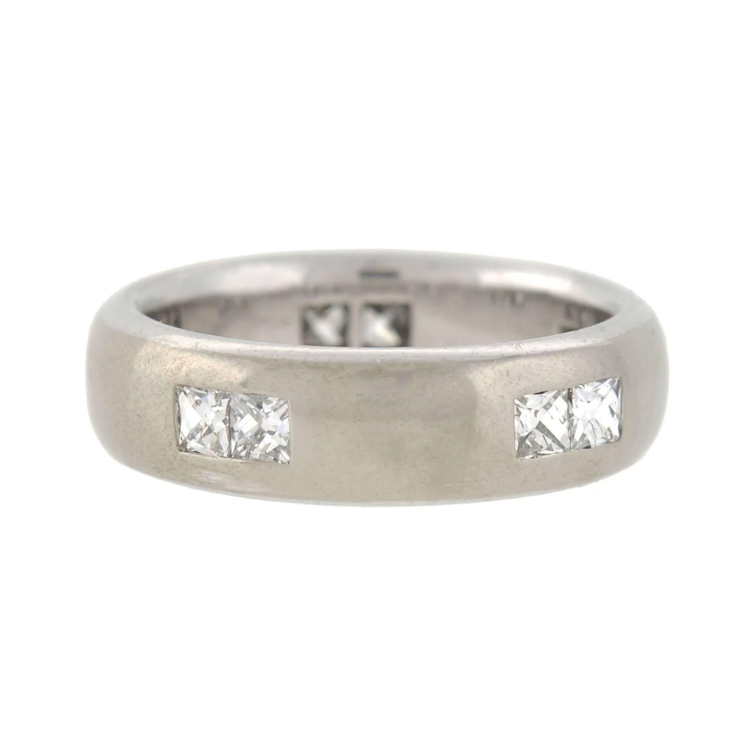 A fabulous Estate French Cut diamond band with a very unique look! Made of 18kt white gold, the band is fairly wide and has attractive beveled sides all the way around. A total of 10 sparkling diamonds decorate the outer surface of the ring, each