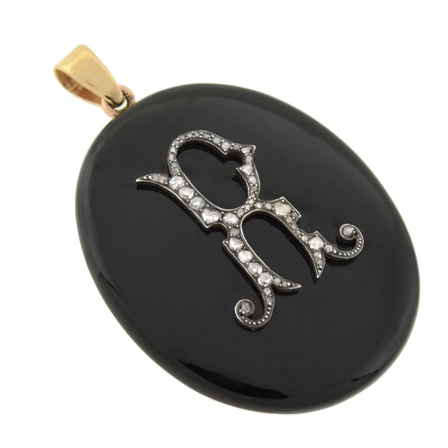An incredible onyx and diamond locket/pendant from the Victorian (ca1880) era! This impressive piece is carved from a solid piece of onyx, and is quite substantial in size. The onyx is smoothly polished for a glossy, rich black finish. Adorning the