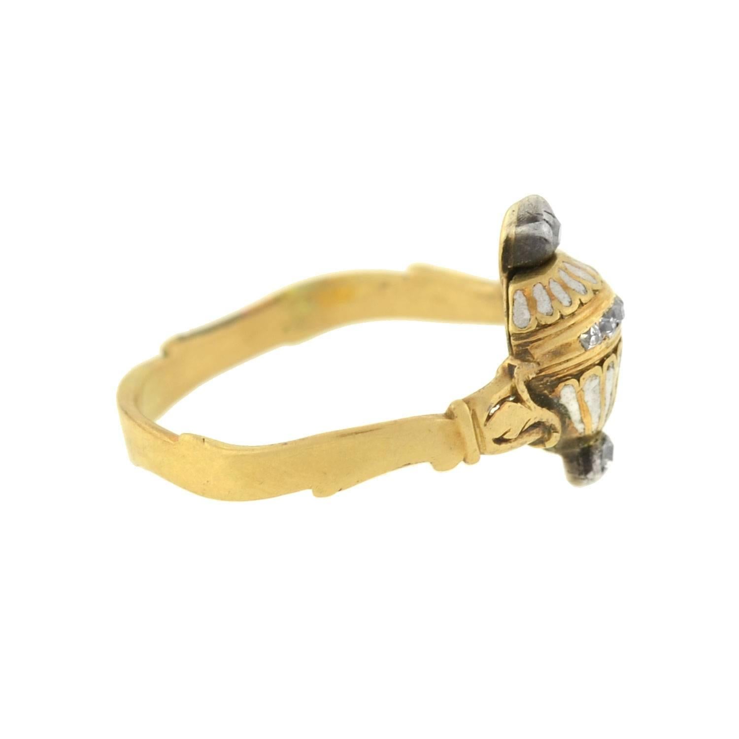 This rare memorial urn ring from the Georgian era (ca1750) is quite an unusual piece! Crafted in 18kt gold, the ring is richly detailed, and serves as a fine example of the mourning jewelry tradition. Framed between the gold band is a delicate
