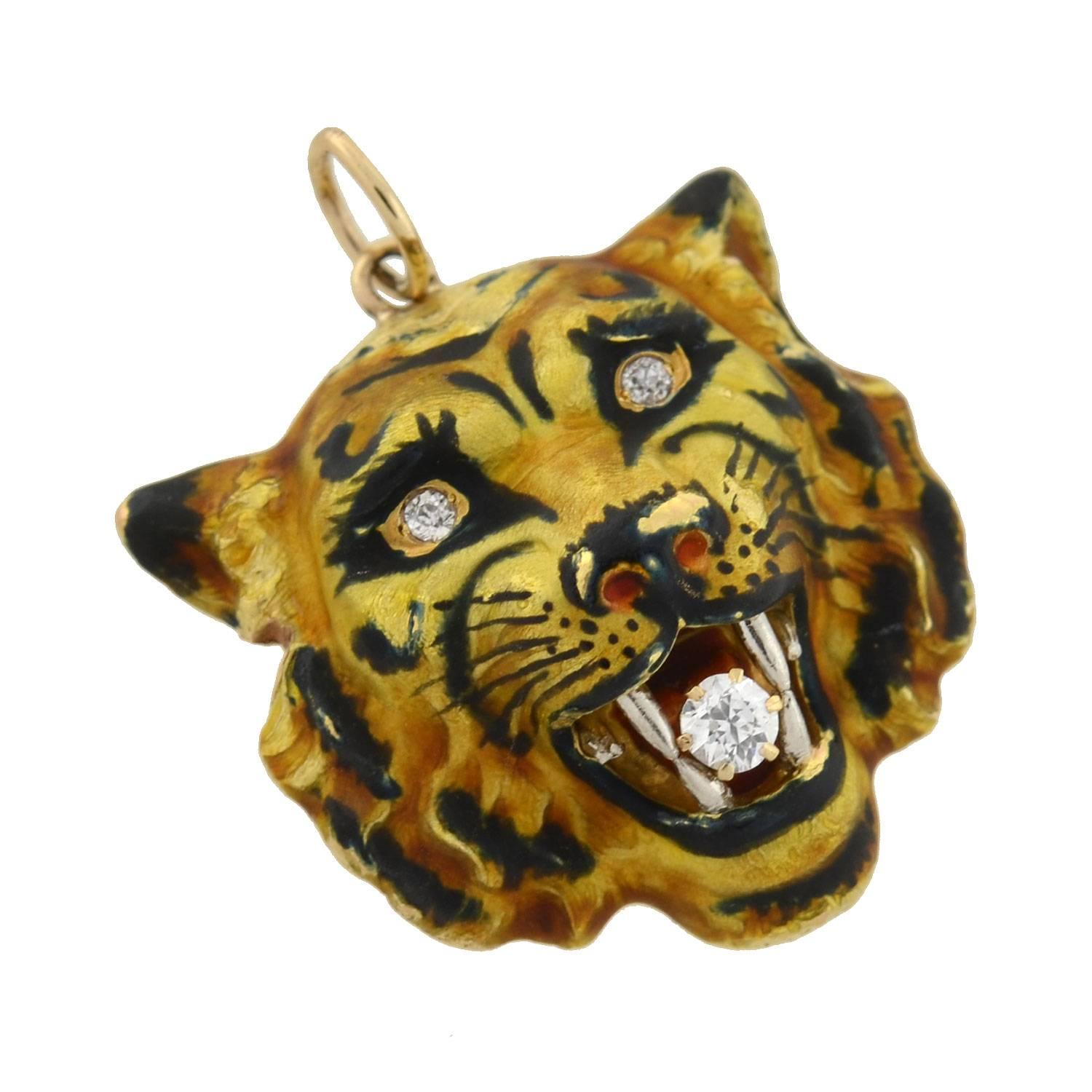 A magnificent enameled pendant from the Victorian (ca1880) era! Crafted in vibrant 14kt gold, the piece represents the 3-dimensional repousse face of a fierce, snarling tiger. Luscious hand-painted enamel accents cover the surface, creating an