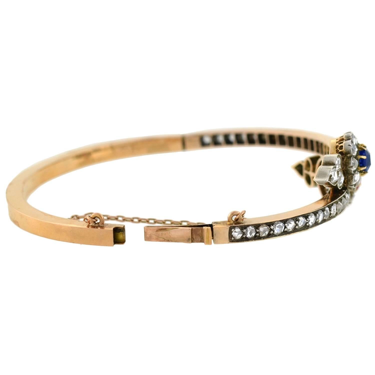 A spectacular gemstone bracelet from the Victorian (ca1880) era! The bracelet is crafted in 18kt rose gold, and is topped with sterling silver along the front. A bypass design is the main focal point of the bracelet, which is heavily encrusted with