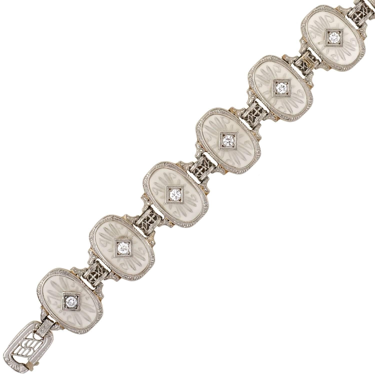 This gorgeous rock quartz crystal bracelet was made by Krementz during the Art Deco (ca1920) era! The 14kt white gold setting is topped in platinum, and displays a row of rock quartz crystal links. Delicate accent diamonds are set at the center of