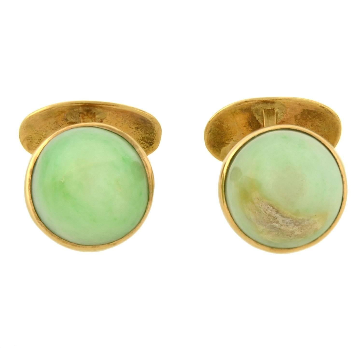 A wonderful pair of jade cufflinks from the Art Deco (ca1920s) era! Each cufflink is crafted in 14kt gold, and has a simple, yet stylish design. The jade cabochons are bezel set, and polished into a smooth, conical shape.They exhibit a soft, milky