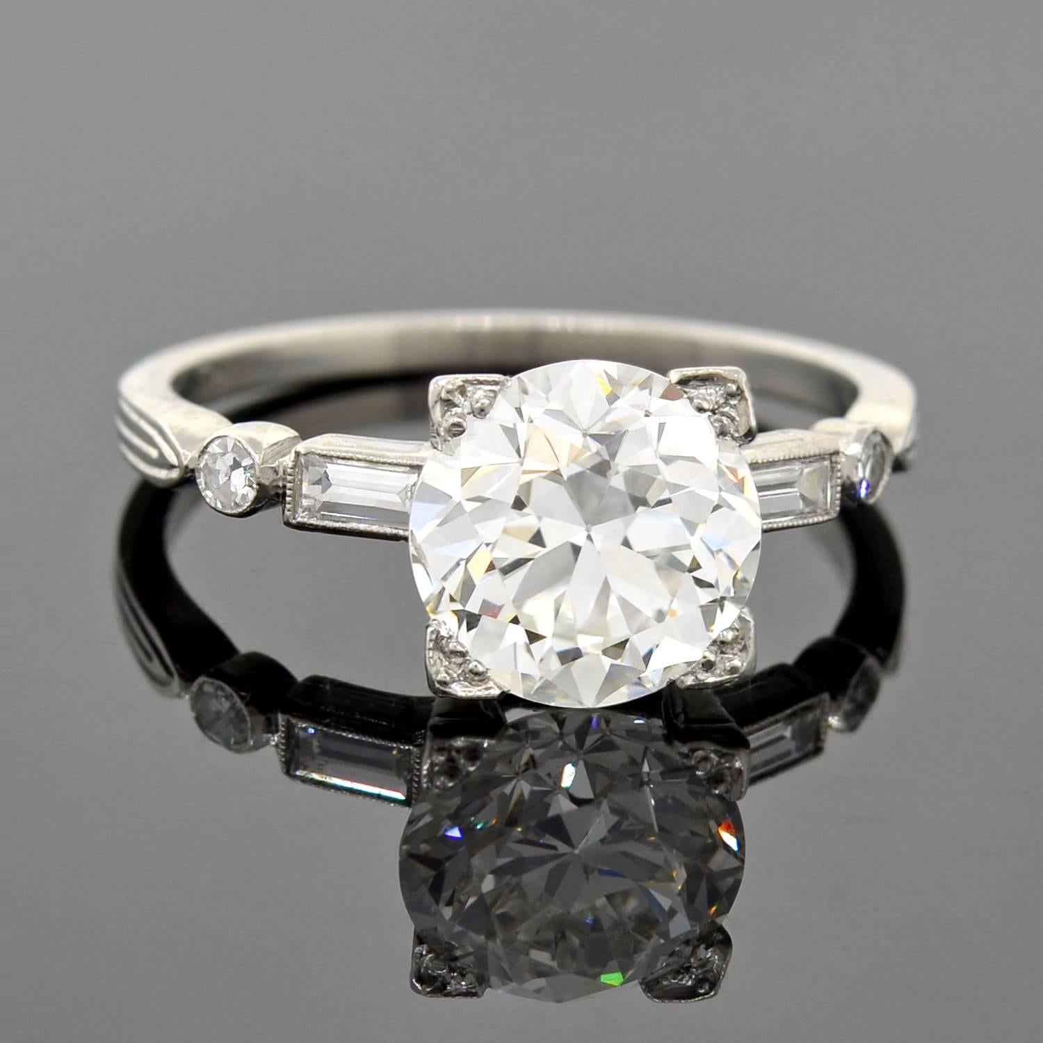 An exquisite diamond engagement ring from the late Art Deco (ca1930s) era! This gorgeous piece is made of platinum and holds a sparkling old European cut diamond at the center of its lovely setting. The center diamond is held within a box prong