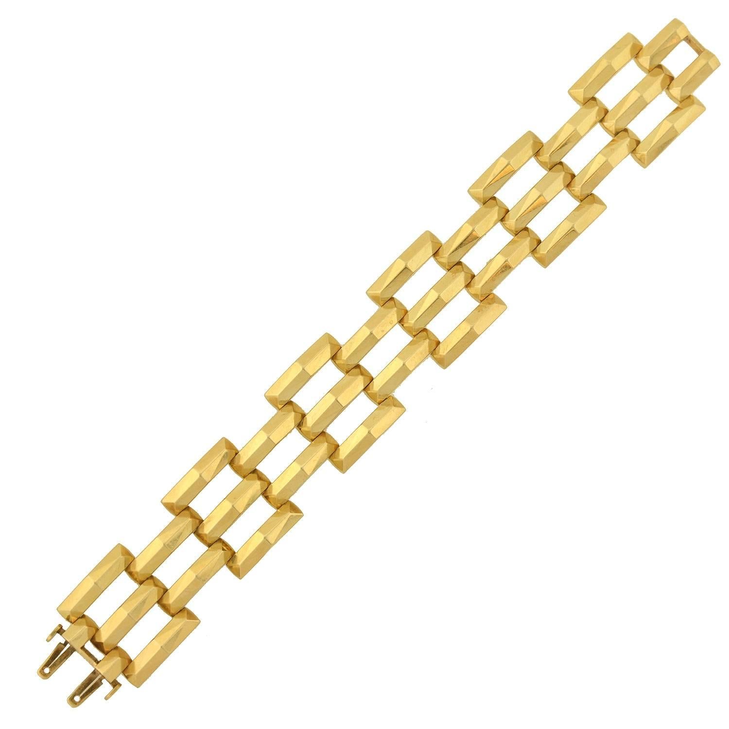 This fabulous vintage bracelet from the 1950s is a signed piece by Tiffany & Co! Made of 14kt gold, the bracelet has a stylish gate link design. Three rows of intersecting links are hinged together with hidden pins, creating the illusion of stacked