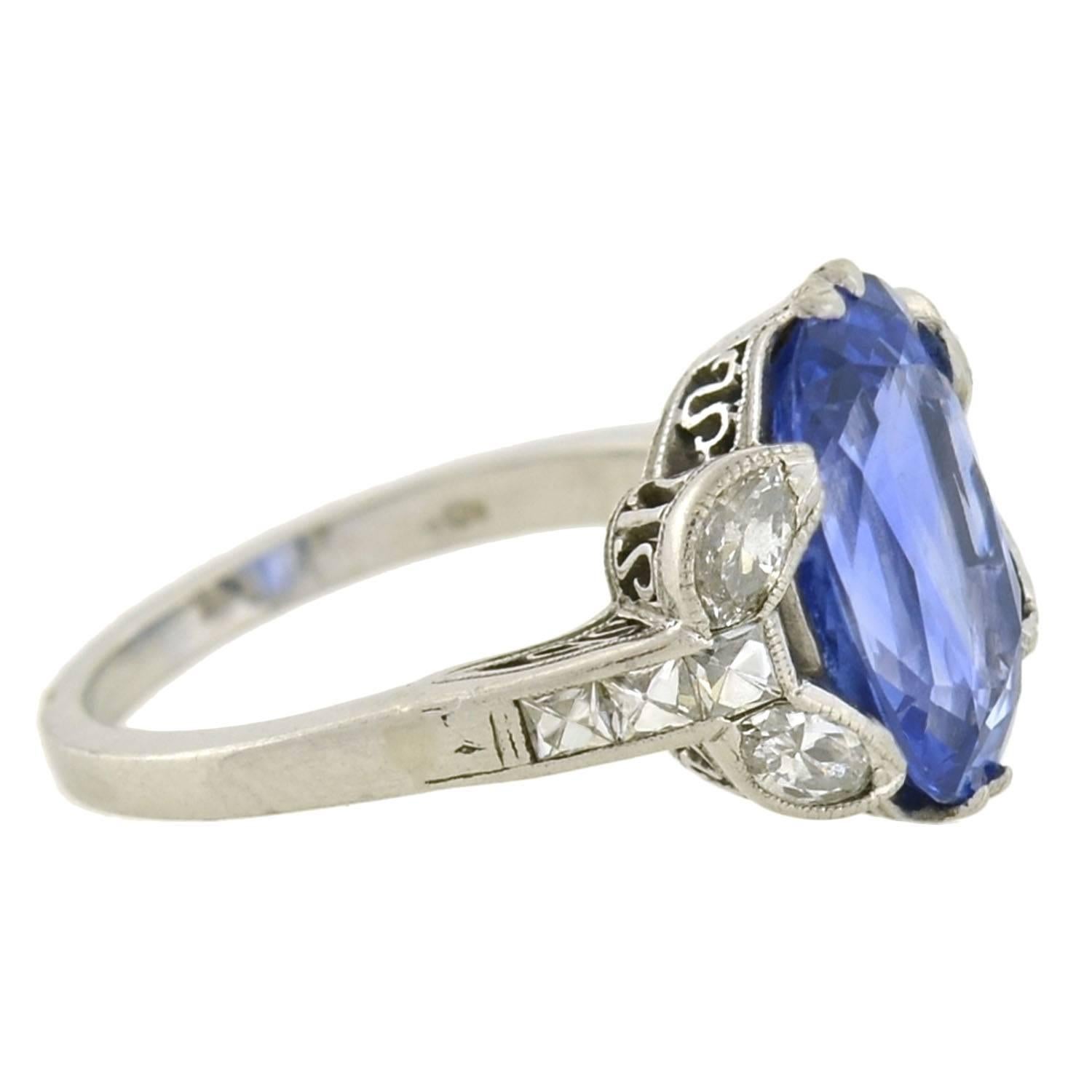 An exquisite sapphire ring from the Art Deco (ca1930s) era! Made of platinum, the ring holds a stunning natural sapphire at the center, framed by sparkling diamonds at either shoulder. The Ceylon (Sri Lankan) sapphire weighs approximately 4.15ct,