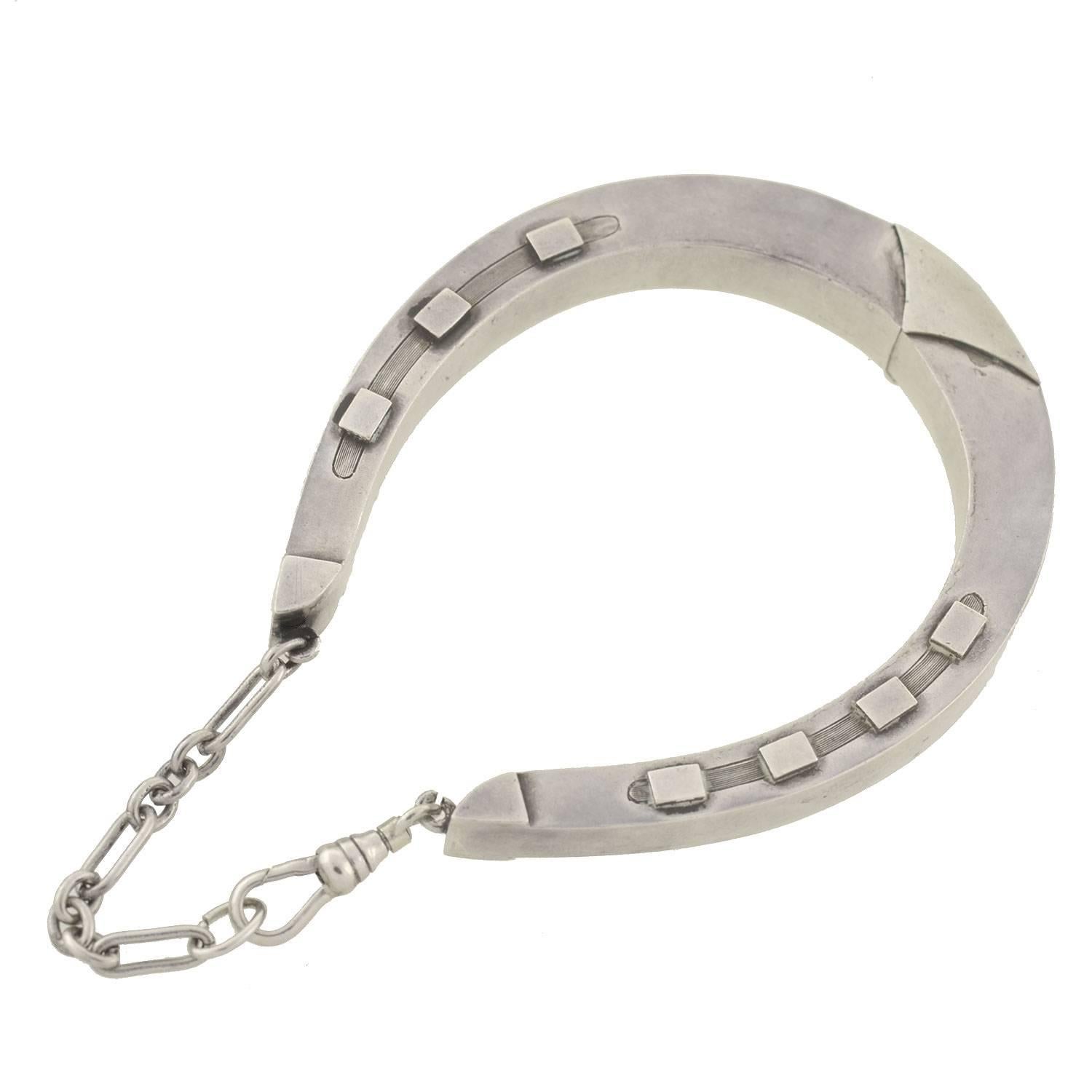 A fabulous horseshoe bracelet from the Victorian (ca1880) era! This gorgeous piece is made of sterling silver and forms the shape of a large horseshoe. Both sides of the reversible bracelet are detailed with 7 raised nails (always 7 for good luck!)