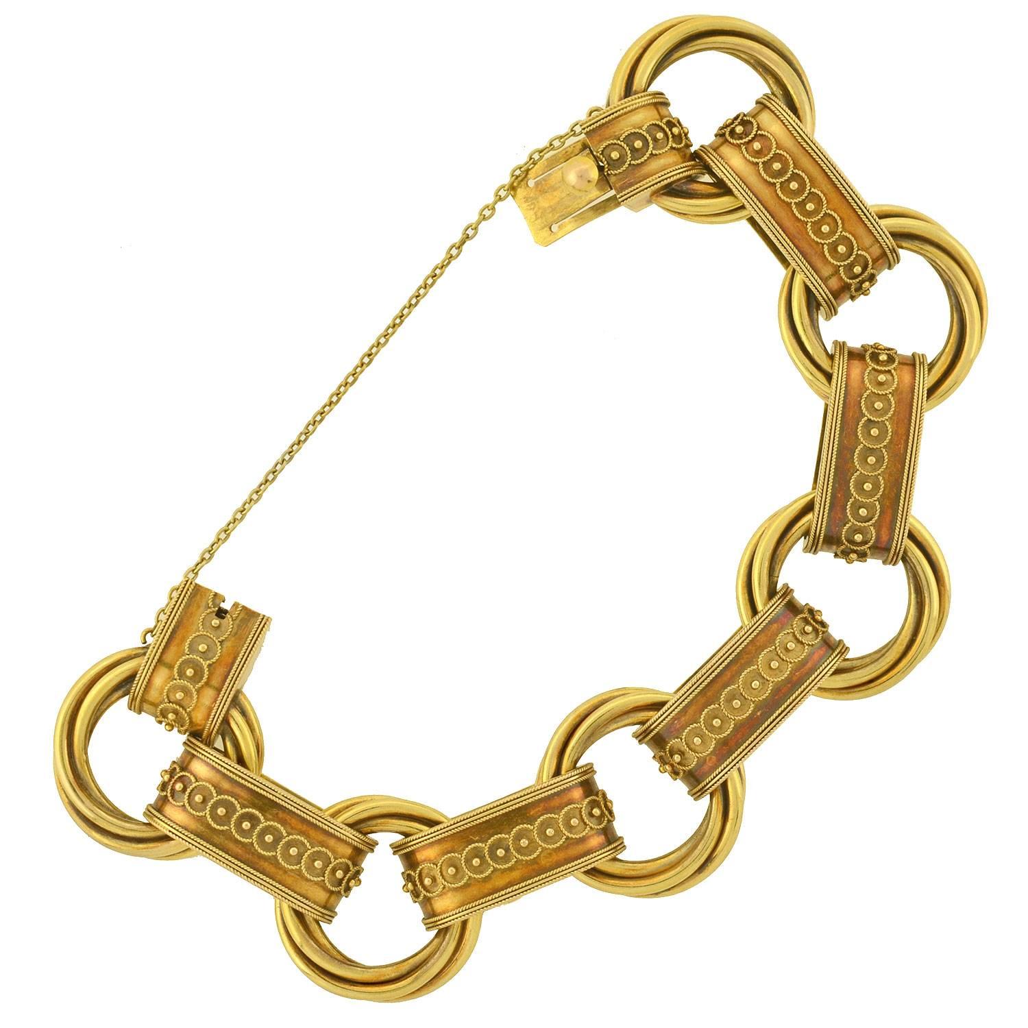 This unusual gold link bracelet from the Victorian era (ca1880) is quite a special piece! The bracelet is crafted in vibrant 18kt yellow gold, and is comprised of an alternating design of 12 book chain links. Fine Etruscan wirework and beadwork