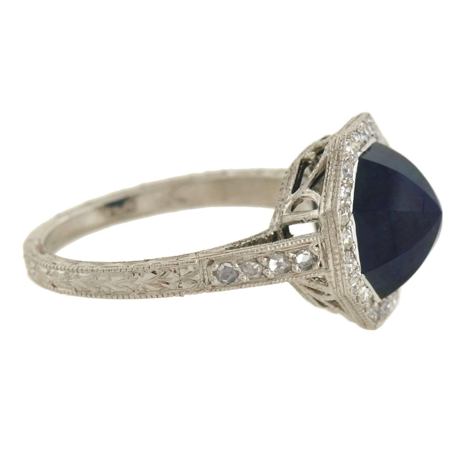 This highly unusual gemstone ring is from the Art Deco (1920) era ! The design has an octagonal-shaped centerpiece crafted in platinum. Resting at the center is a 2.25ct deep blue sapphire, which has a fancy 8-sided cut that comes to a point at the