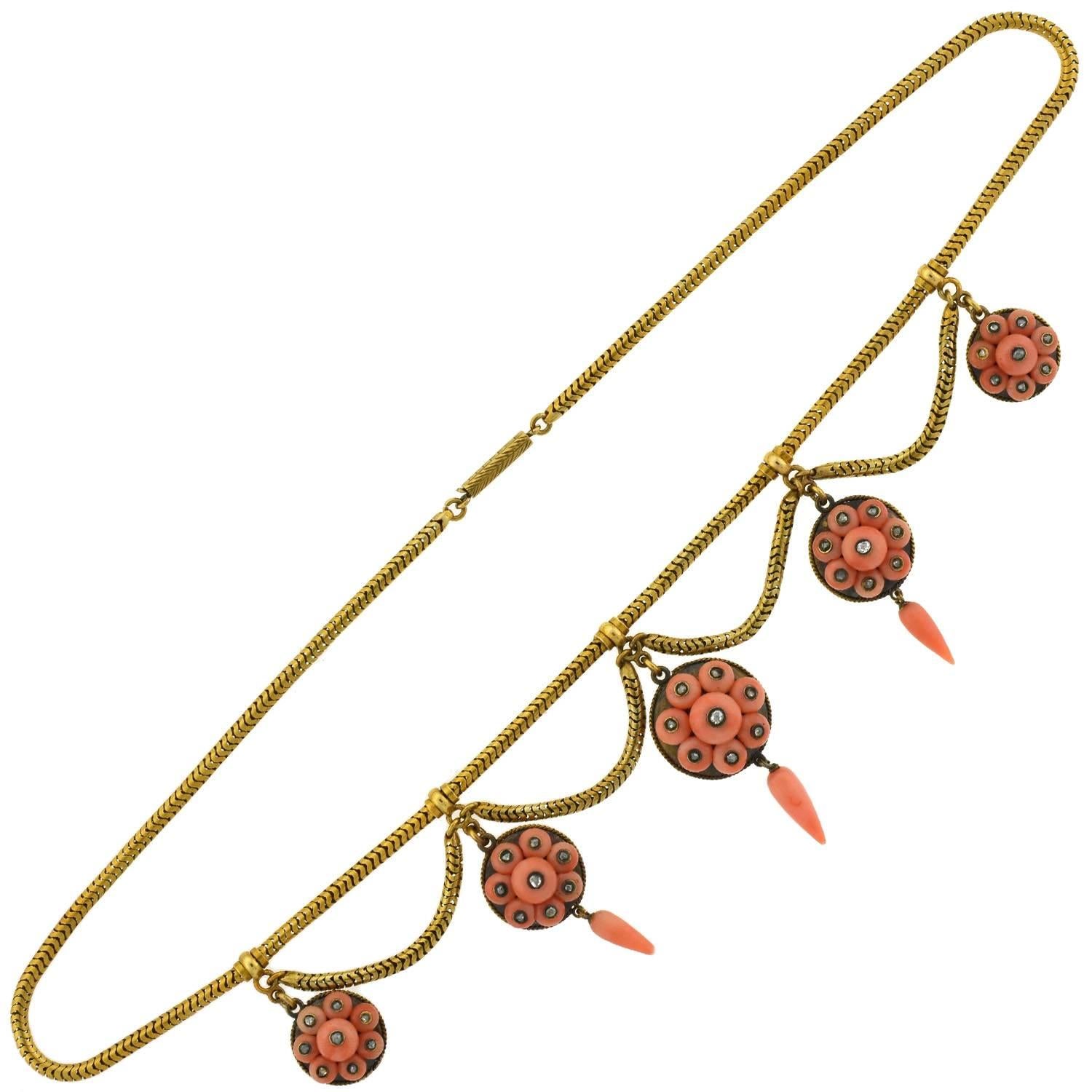 A beautiful coral necklace from the Victorian (ca1880) era! This stunning necklace features an ensemble of coral links that hang from a 15kt gold chain in a festoon fashion. The graduated links have matching cluster designs, with delicate accent