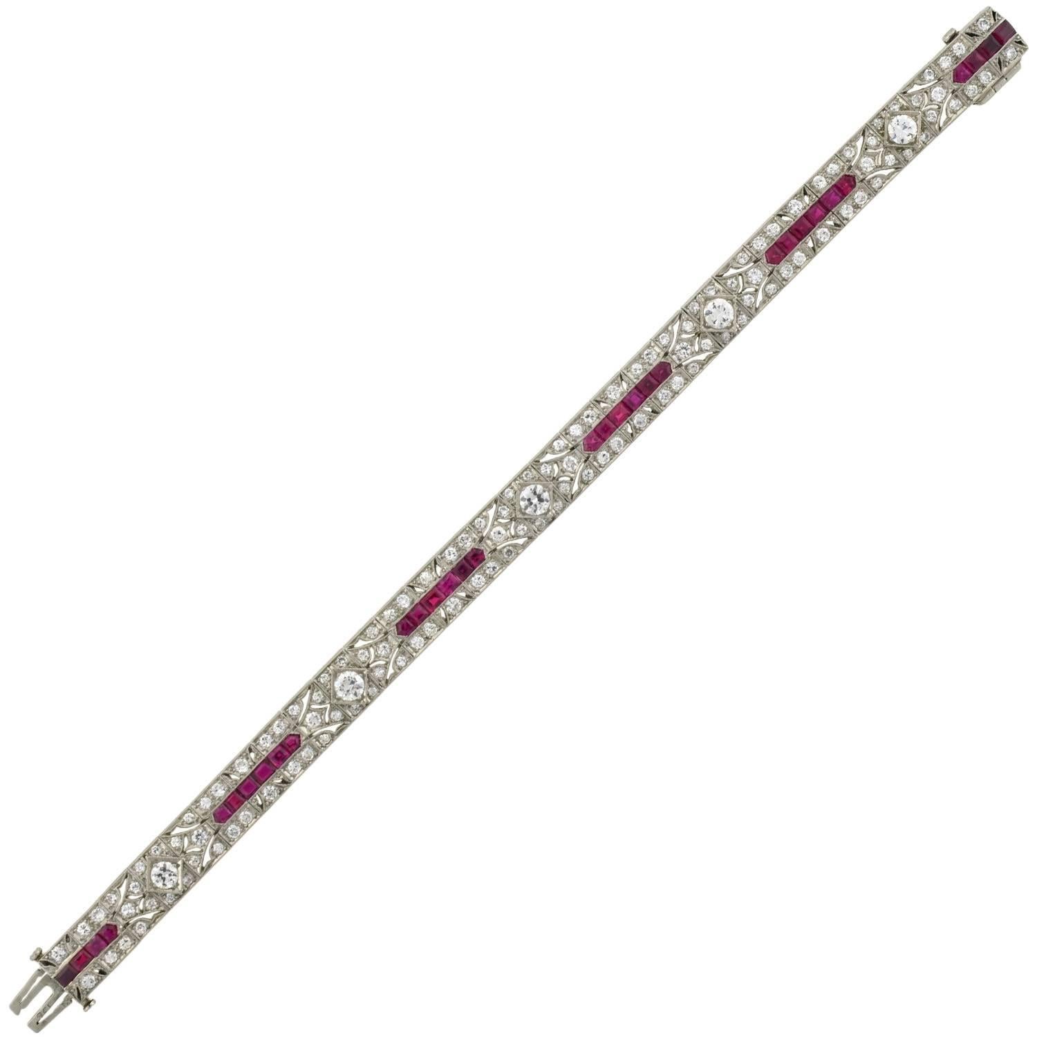 An absolutely stunning and rare diamond and ruby line bracelet from the Art Deco (ca1920-30s) era! Made of platinum, this gorgeous piece is comprised of 30 total links accented with old European Cut diamonds and luscious natural rubies, which wrap